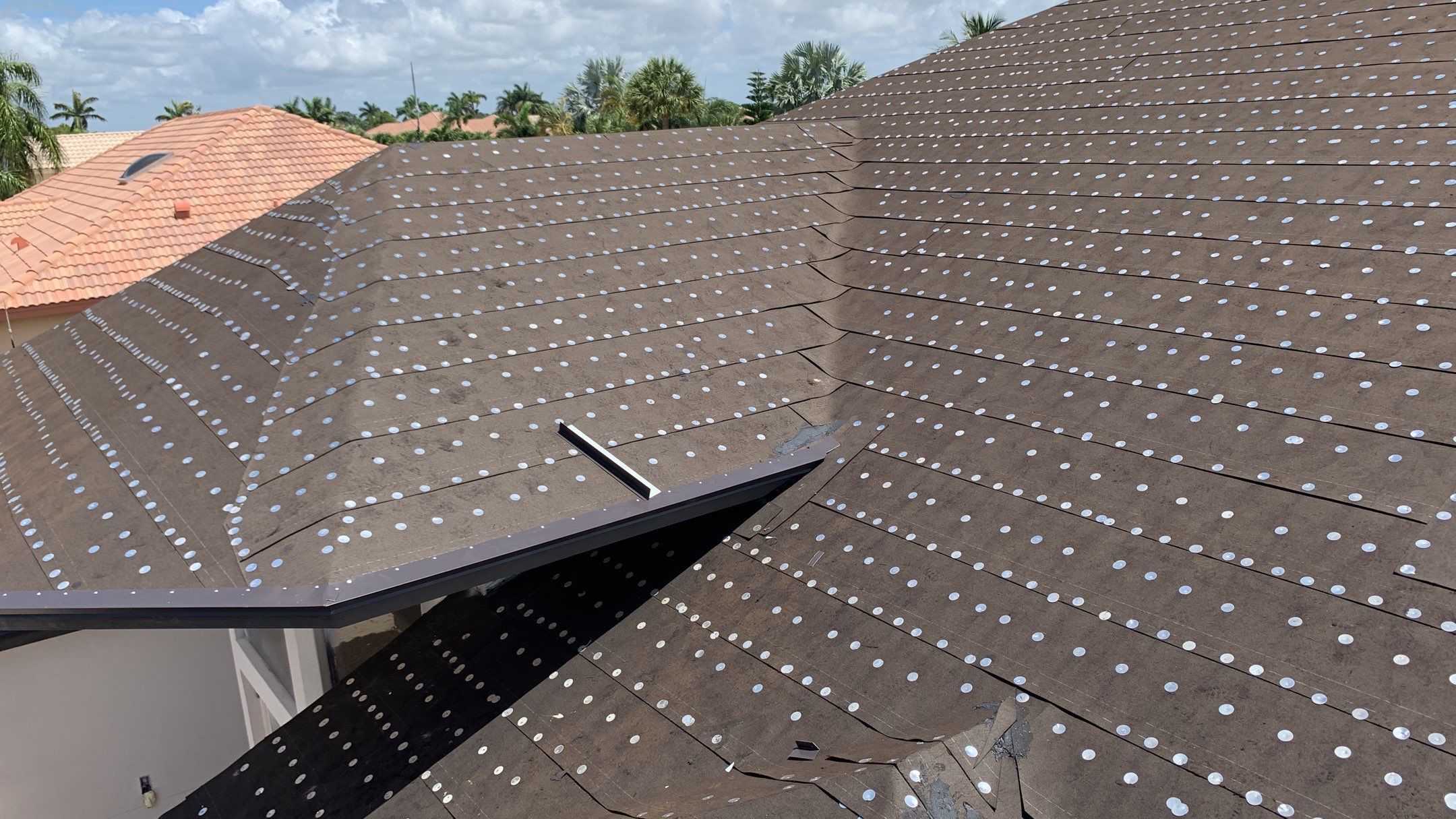 Residential Roofing Installation using 1" Nail strip metal roof by BLUES BROTHERS CONSTRUCTION CORP