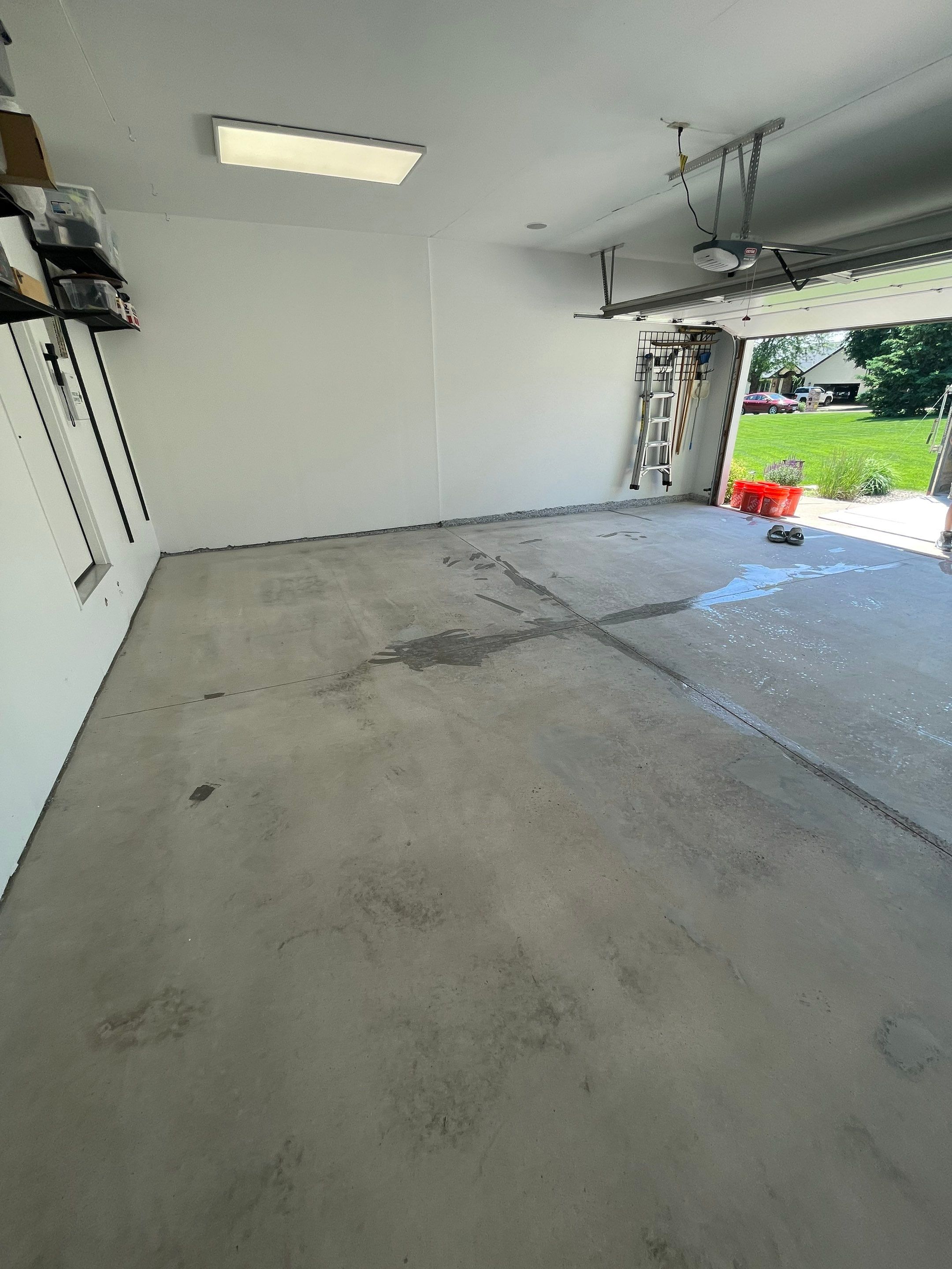 Feather Grey Garage Floor Coating Installation in Sioux Falls by Select Painting, Coatings & Garage Cabinets