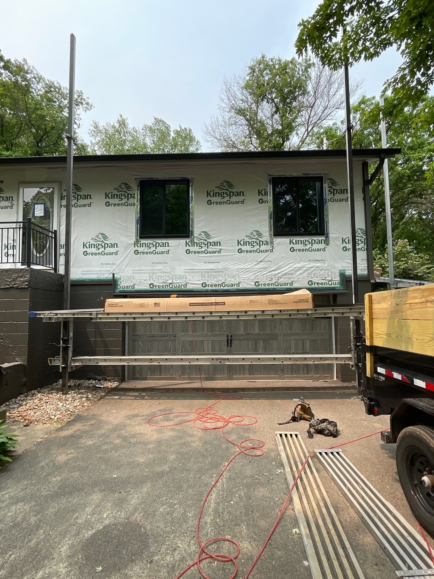 Premium Exterior Remodel – Alside Charter Oak Siding, Hayfield Black Frame Windows, Edco Soffit & Fascia by First Impressions Exteriors
