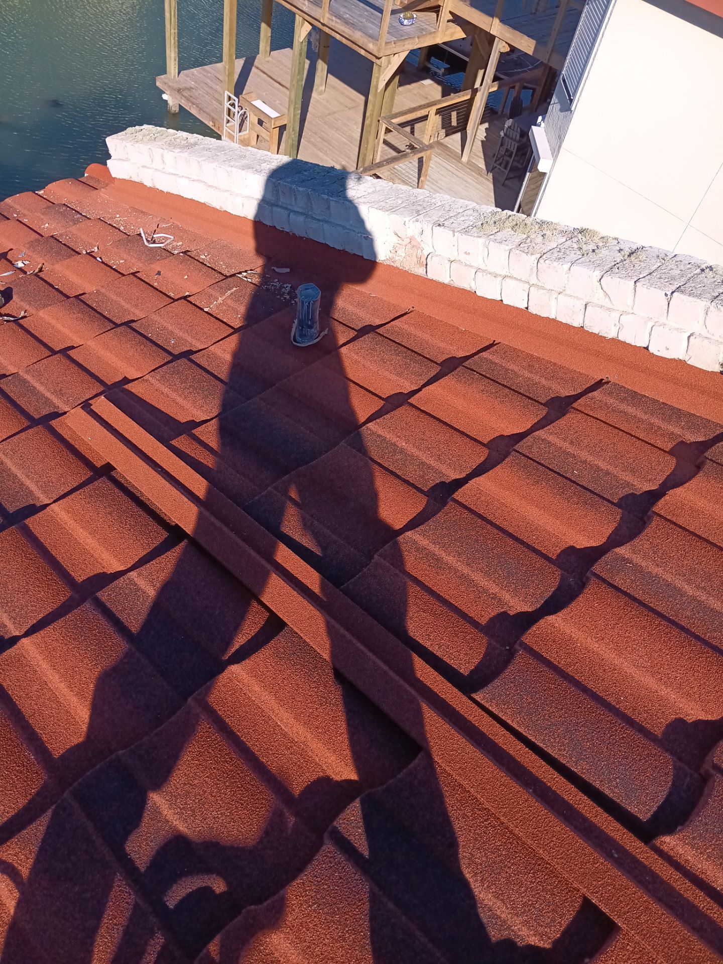 Off with the Tile and on with the TILCOR stone coated metal.  by Bayfront Roofing and Construction