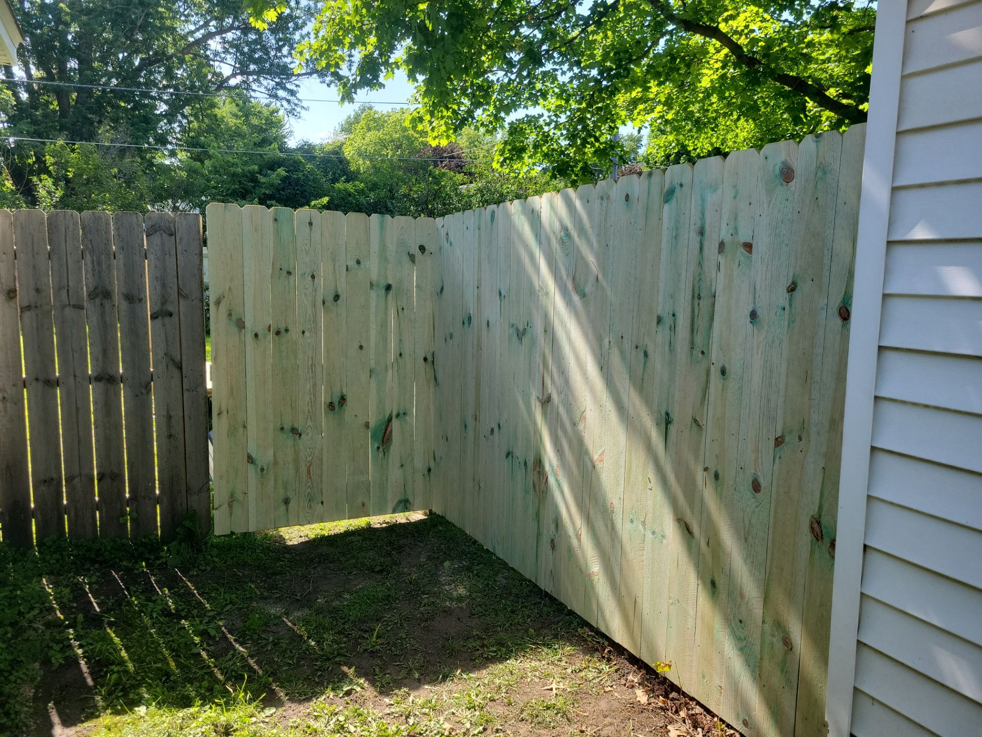 Pressure-Treated Wood Privacy Fence Installation in Charles City by Perfect Picket Fence and Stain