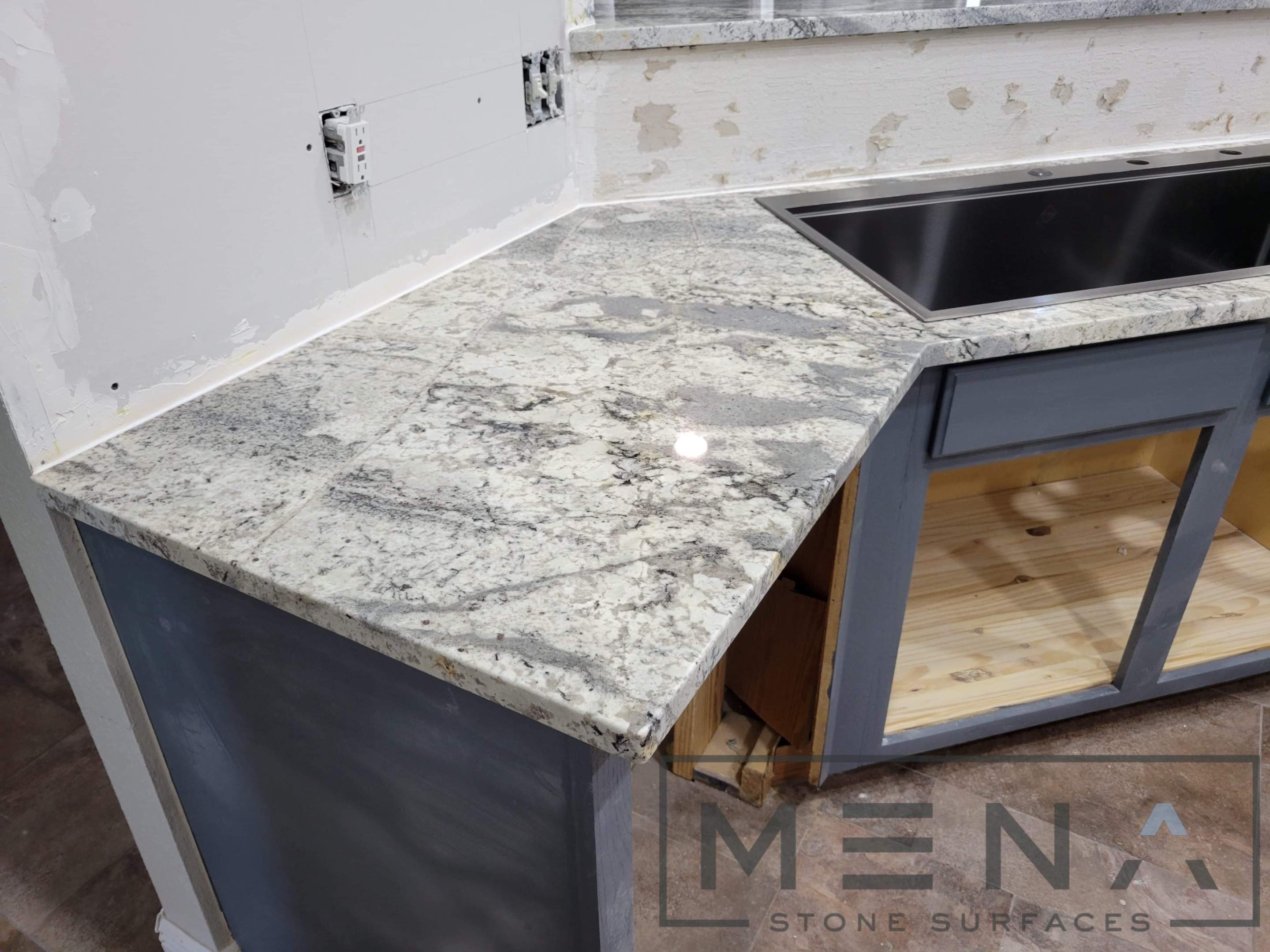 Kitchen countertops using Alaska Blue Granite by Mena stone surfaces