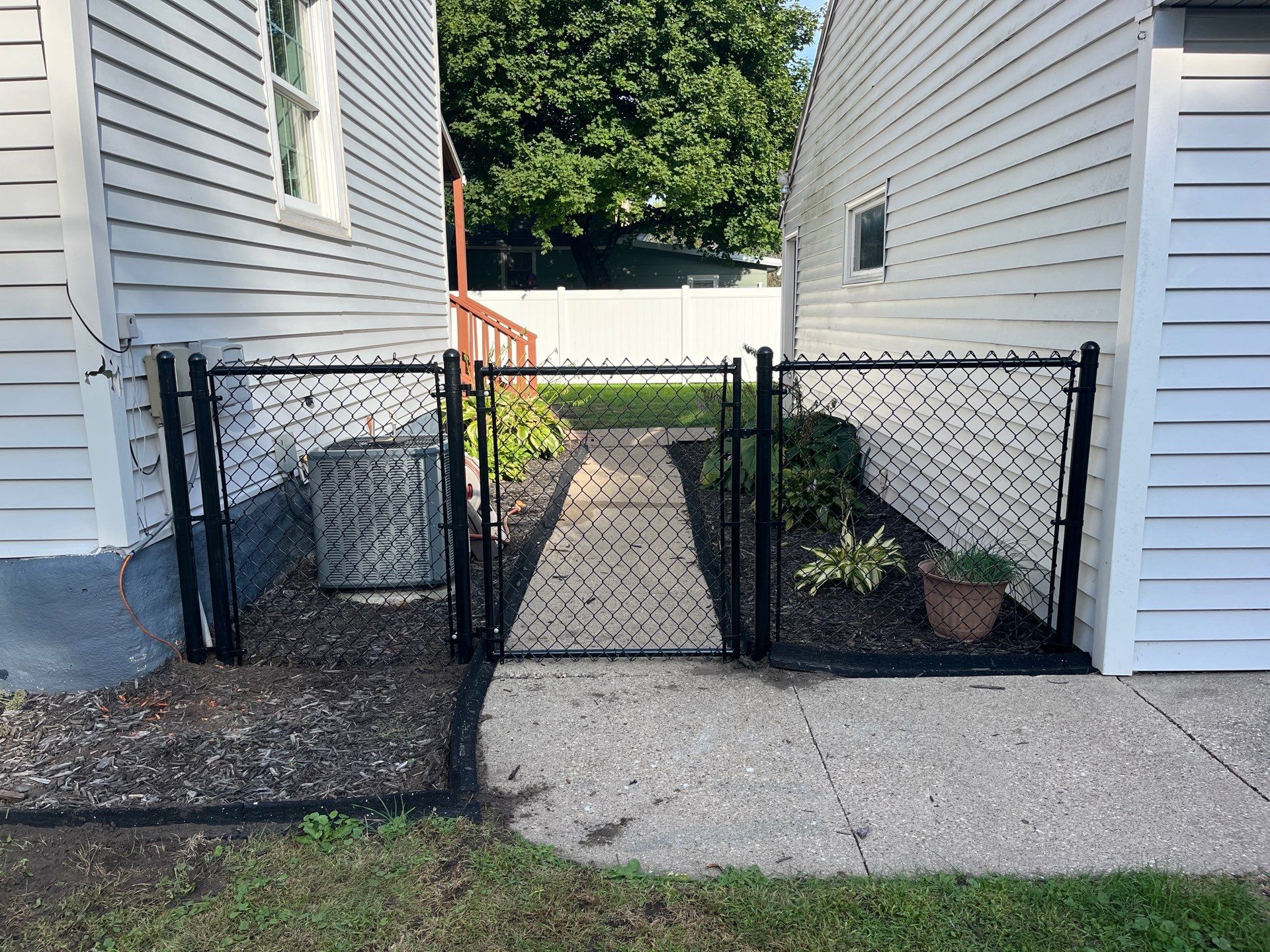 White Vinyl Privacy Fence and Black Chain Link Installation in Sumner by Perfect Picket Fence and Stain