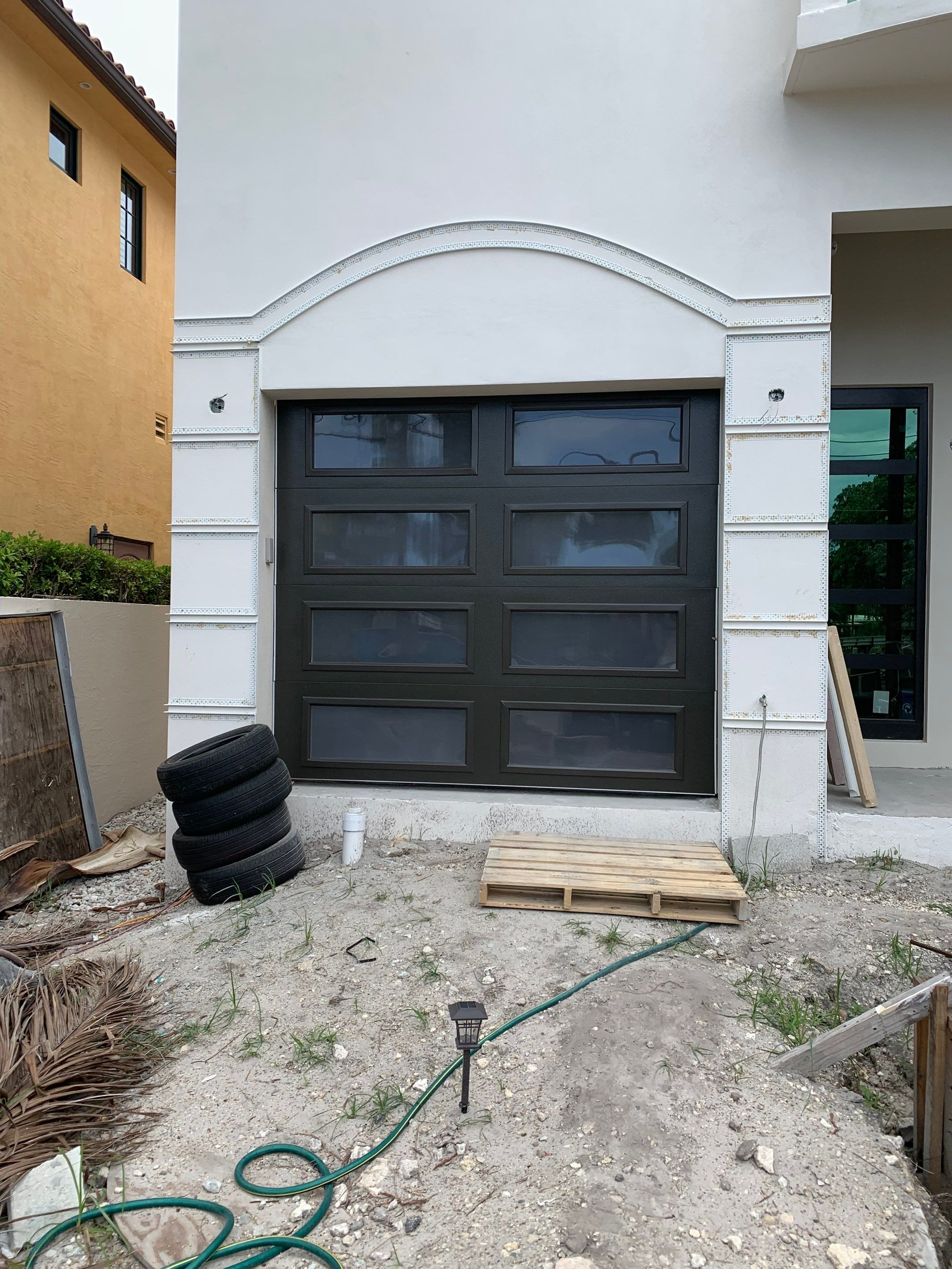 Modern Garage Door Installation for New Construction – Las Olas Isles, Fort Lauderdale, FL by The Door Doctor of South Florida, Inc.