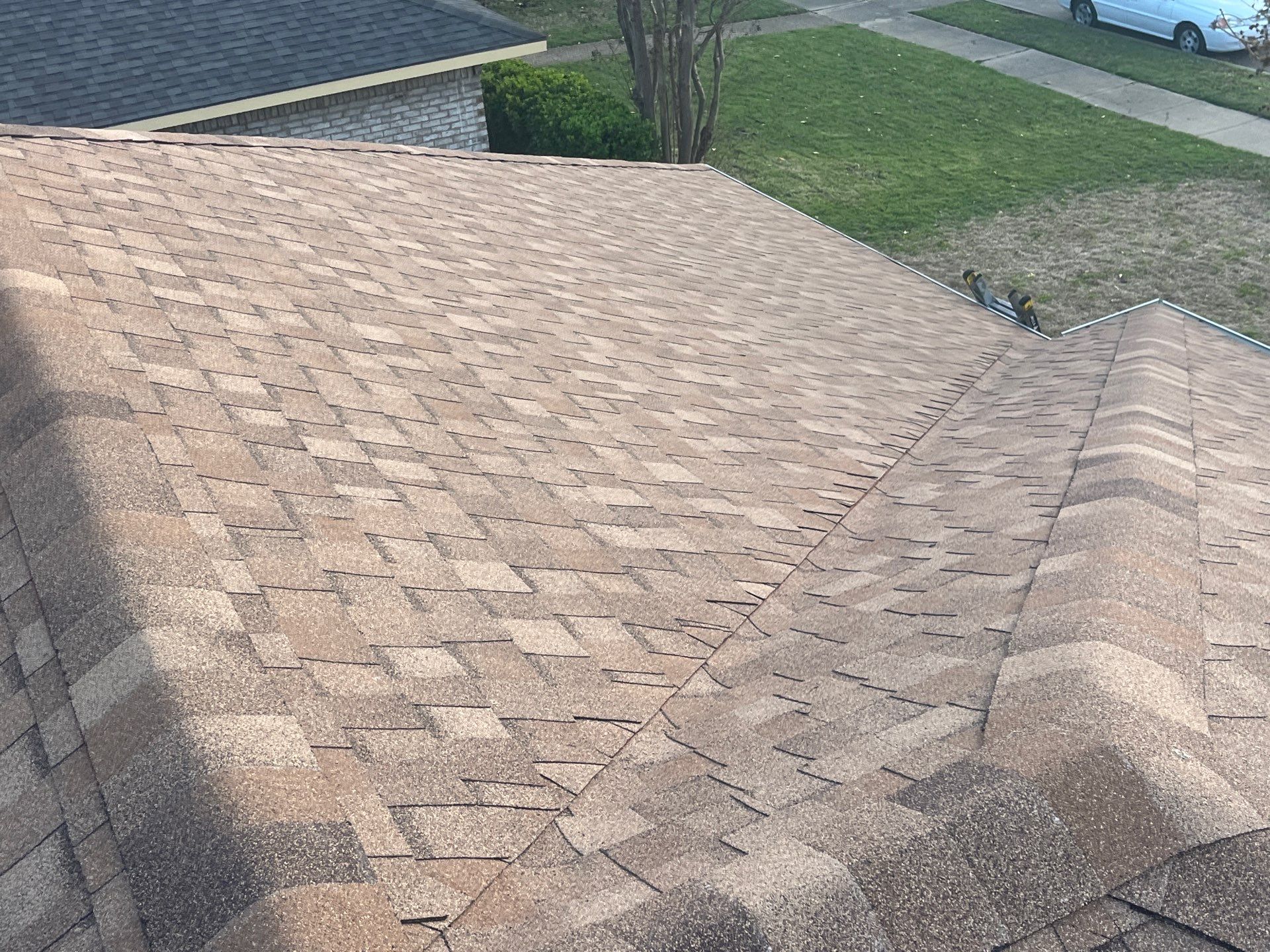Medium brown brick with Tamko Rustic Cedar by Tejas Roofworks + Restoration