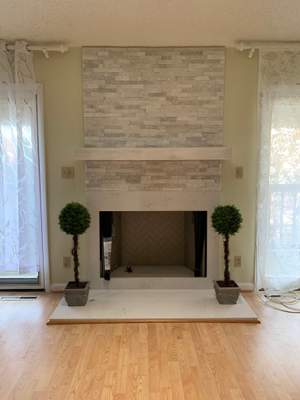 Wood burning fireplace with mixed custom stone finishes