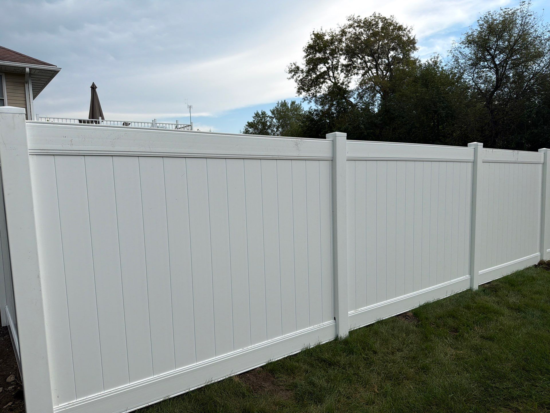 White Vinyl Privacy Fence Installation in Raymond, IA by Perfect Picket Fence and Stain