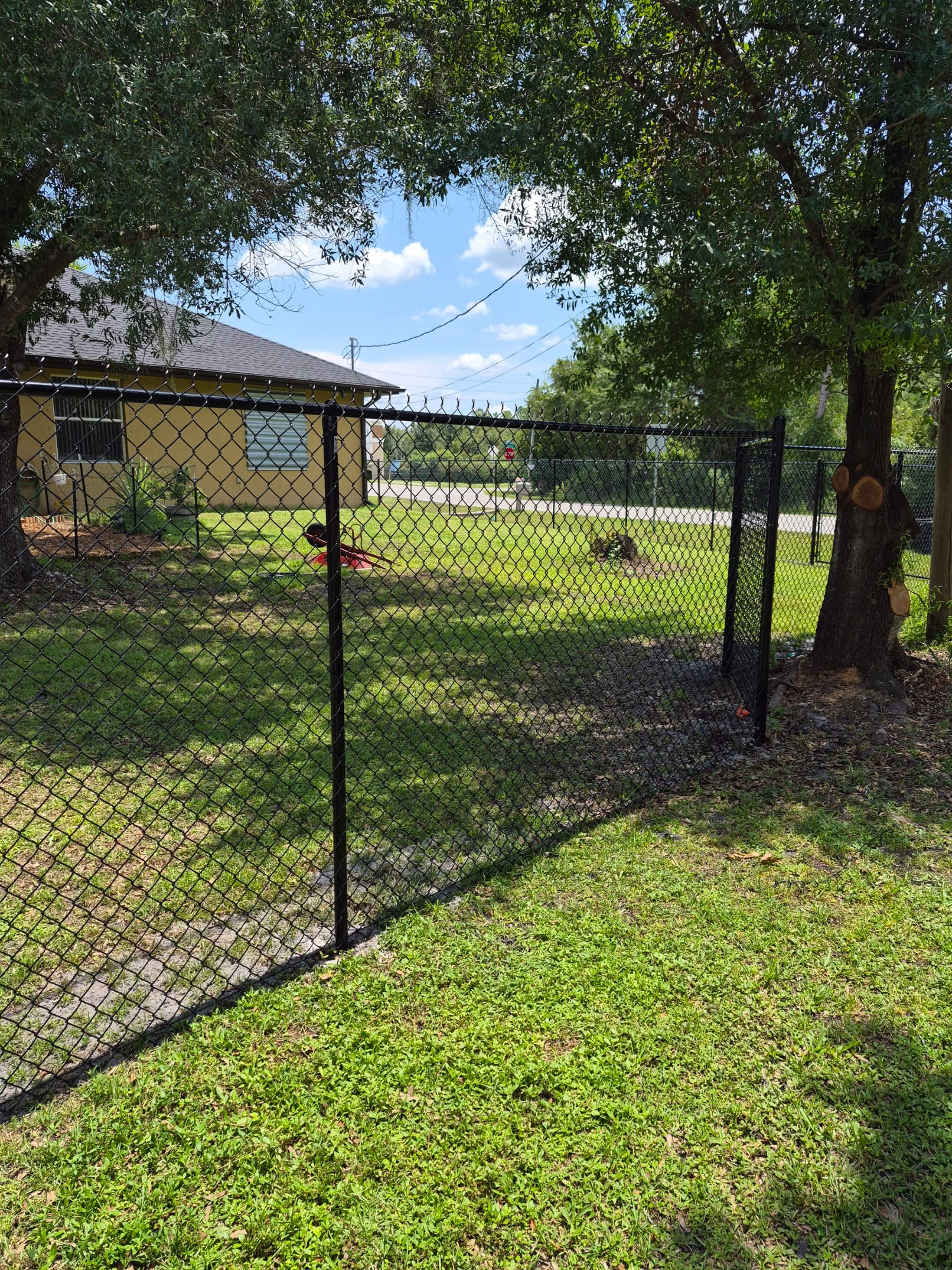 Black Chain Link Perimeter Fencing with Double Gates in Port Charlotte by True Fence LLC