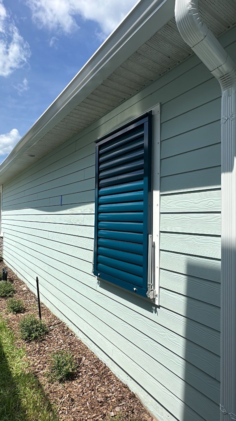 Hurricane Rated Bahama Shutters in Ocean Blue by Smart Guard Shutters