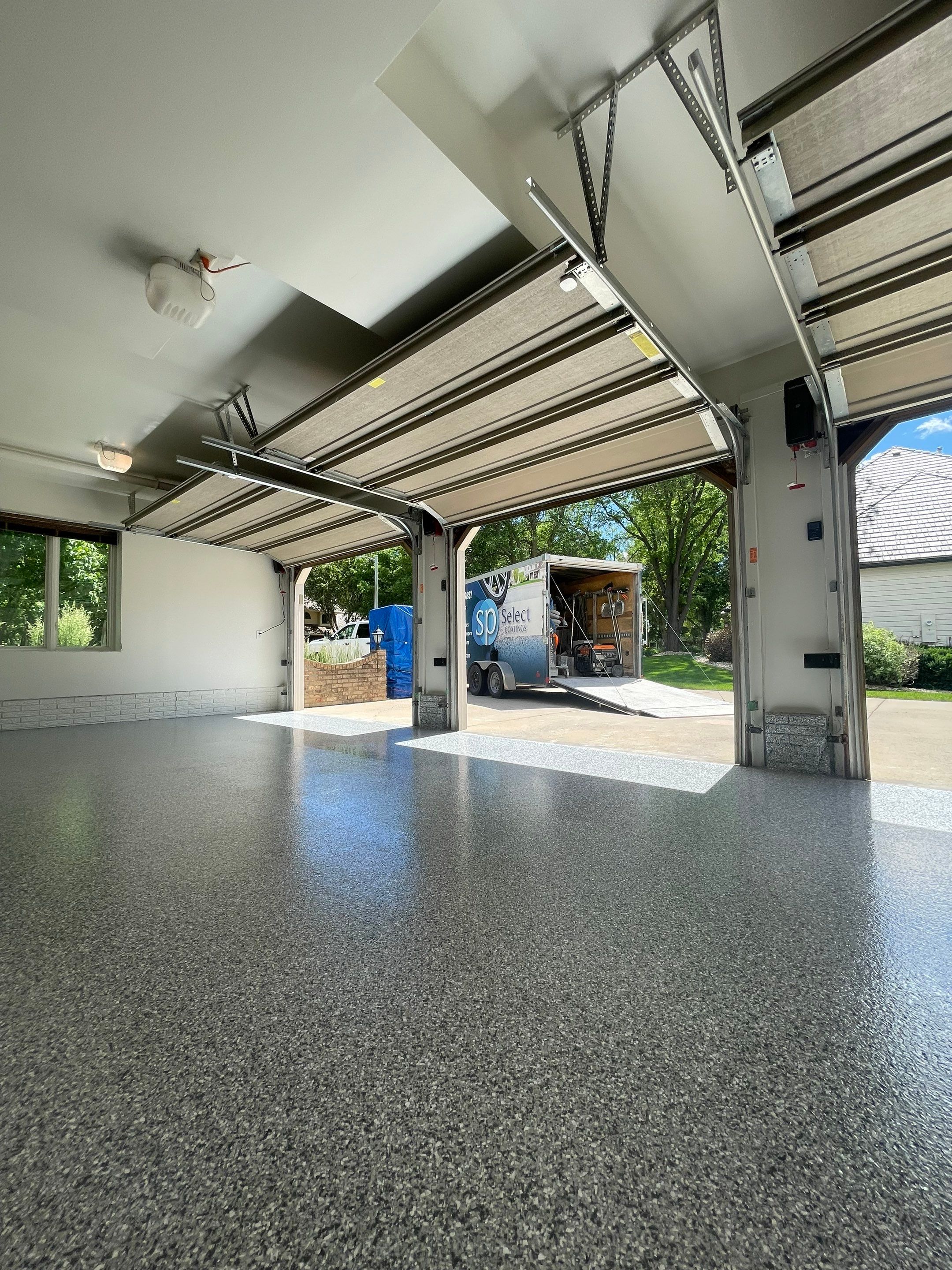 Gray Speckled Epoxy Garage Floor Coating in Sioux Falls by Select Painting, Coatings & Garage Cabinets