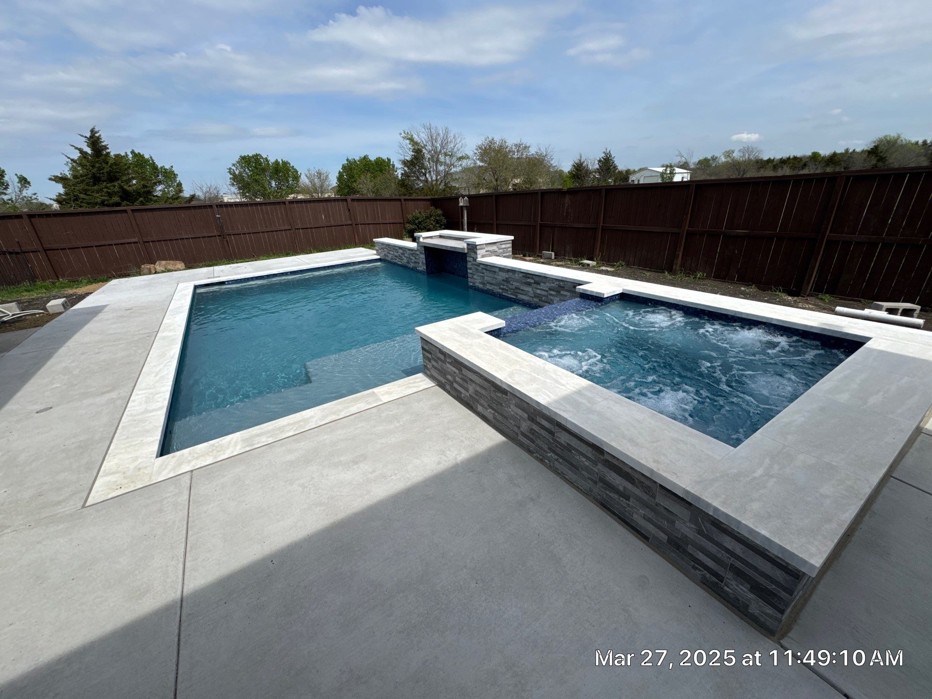 Geometric Pool and Spa with Stone Water Feature Wall by Pinnacle Pools and Spas - DFW