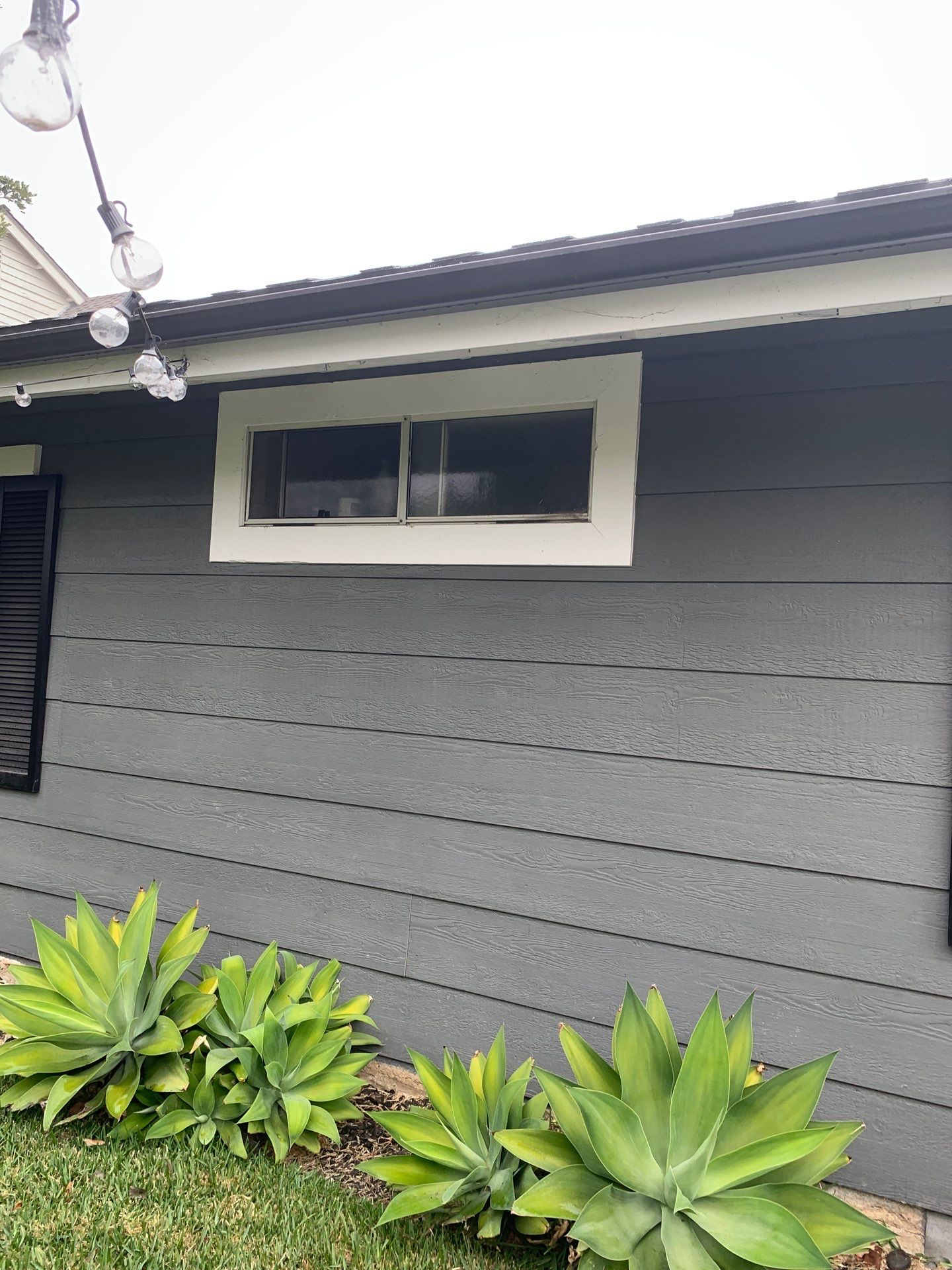 Window Installation using Milgard black vinyl windows by American Window Company