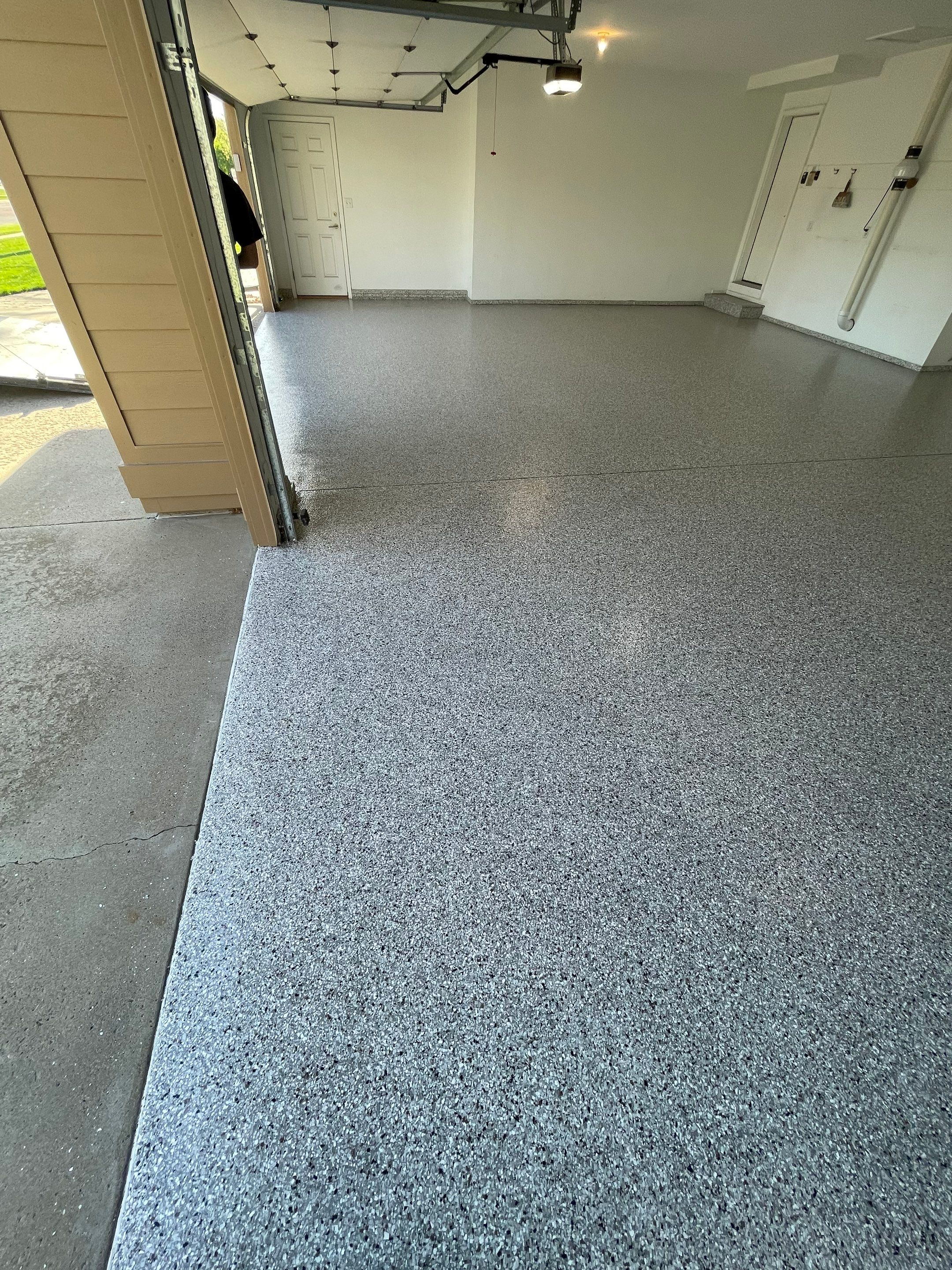 Yankton Garage Floor Restoration with Gray Speckled Epoxy Coating by Select Painting, Coatings & Garage Cabinets