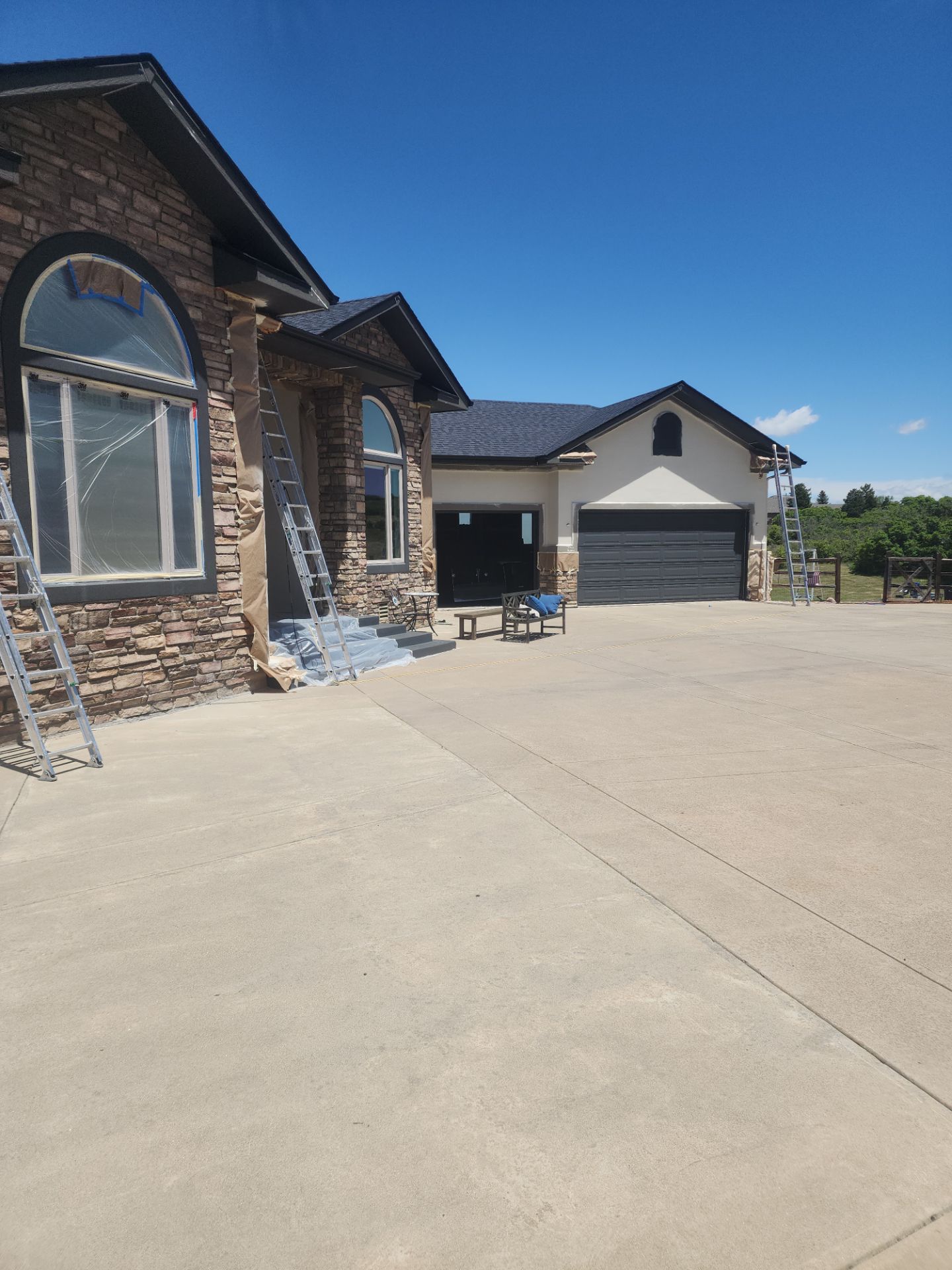 Castle Rock Elegance: White Stucco Exterior with Bold Tricorn Black by J&M Painting LLC