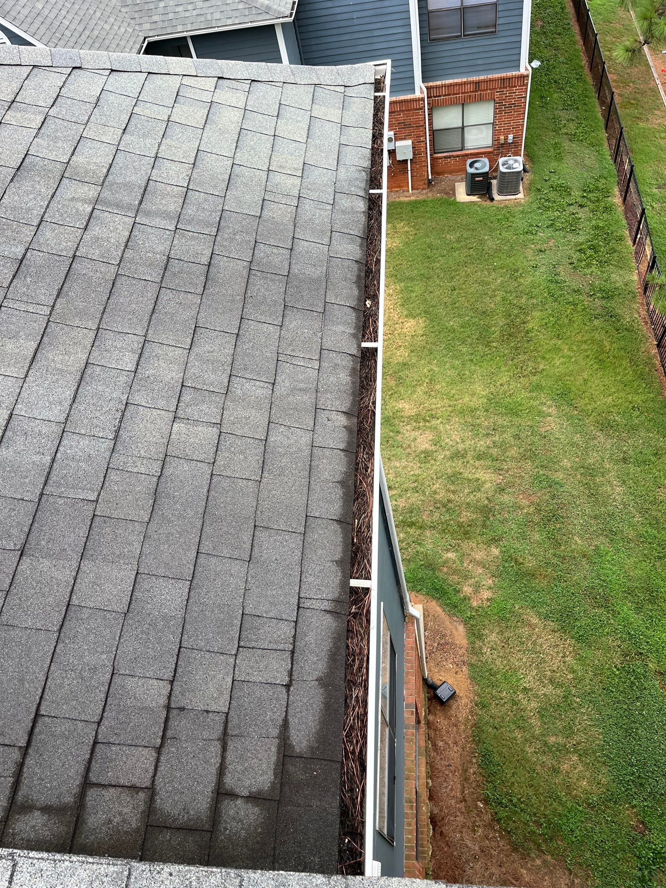 Commercial gutter cleaning Rock Hill & Fort Mill, SC before photo with filled gutters