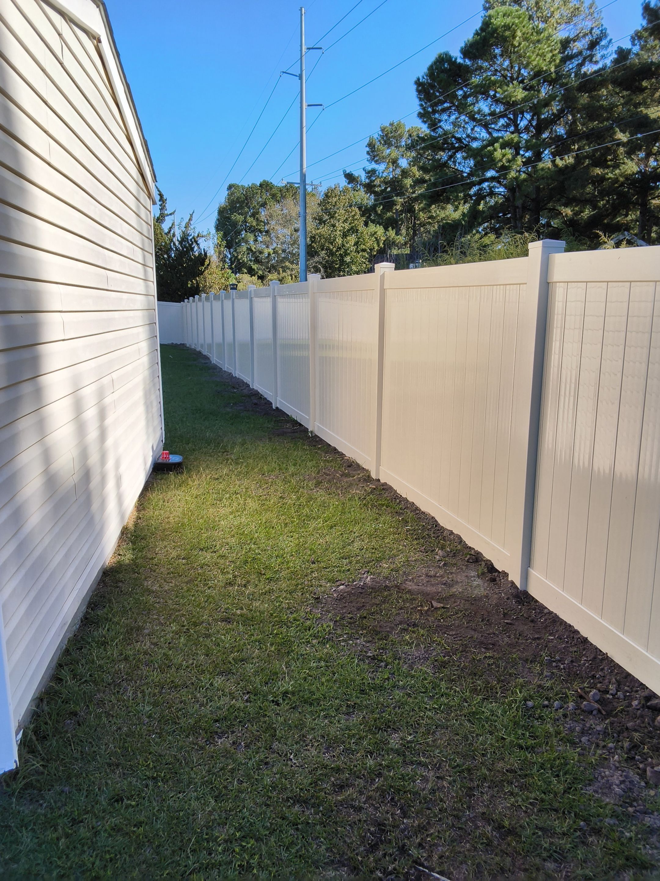 Custom Tan Vinyl Privacy Fence Installation with Double Gates in Winterville by Superior Fence and Rail