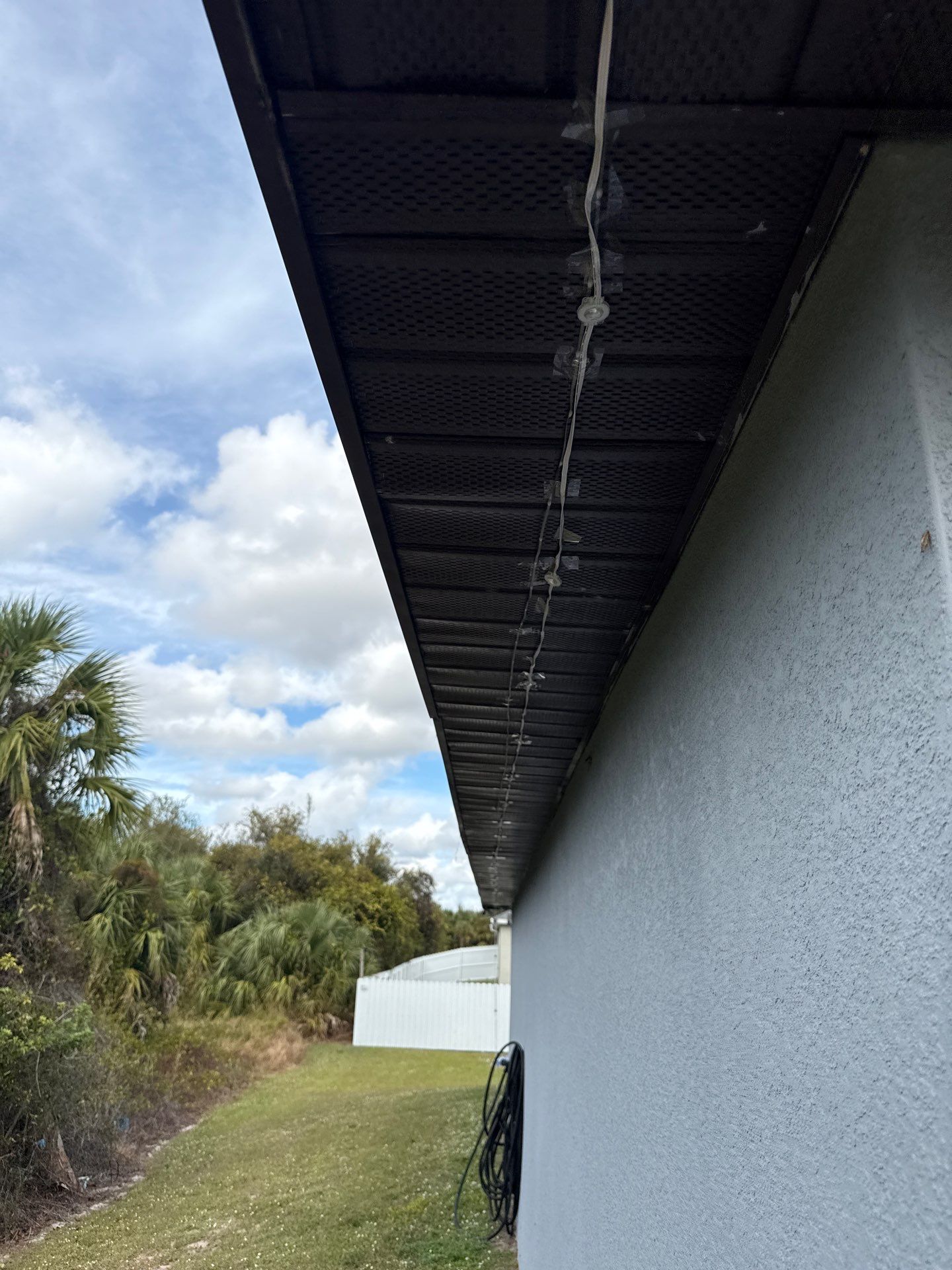 Black Seamless Gutters & Soffit/Fascia in Lehigh Acres FL by Gutter Professors