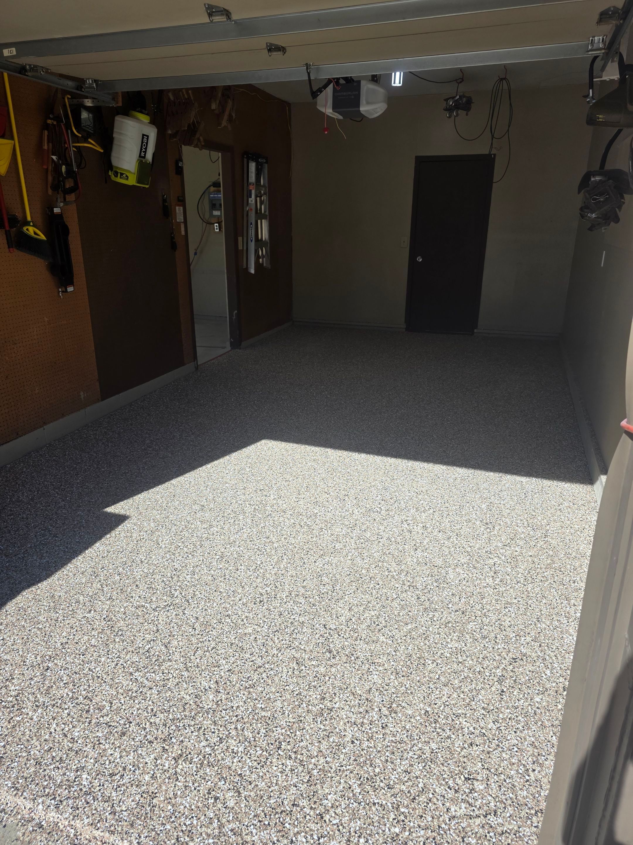 Residential Garage Epoxy Floor Coating Installation in Sioux Falls by Select Painting, Coatings & Garage Cabinets