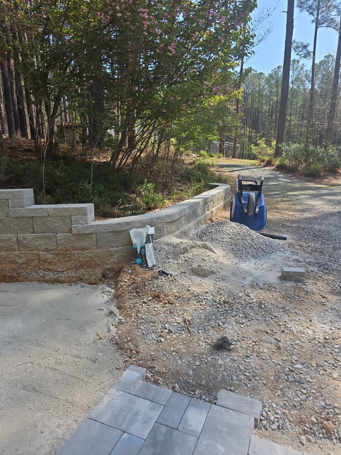 Pittsboro Outdoor Living Transformation – Retaining Wall, Paver Patio & Elevated Deck by Elite Remodeling and Design LLC
