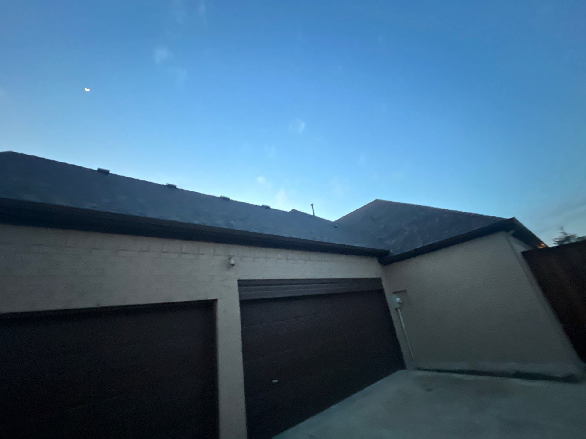 Cream brick/mixed stone with IKO Shadow Brown by Tejas Roofworks + Restoration