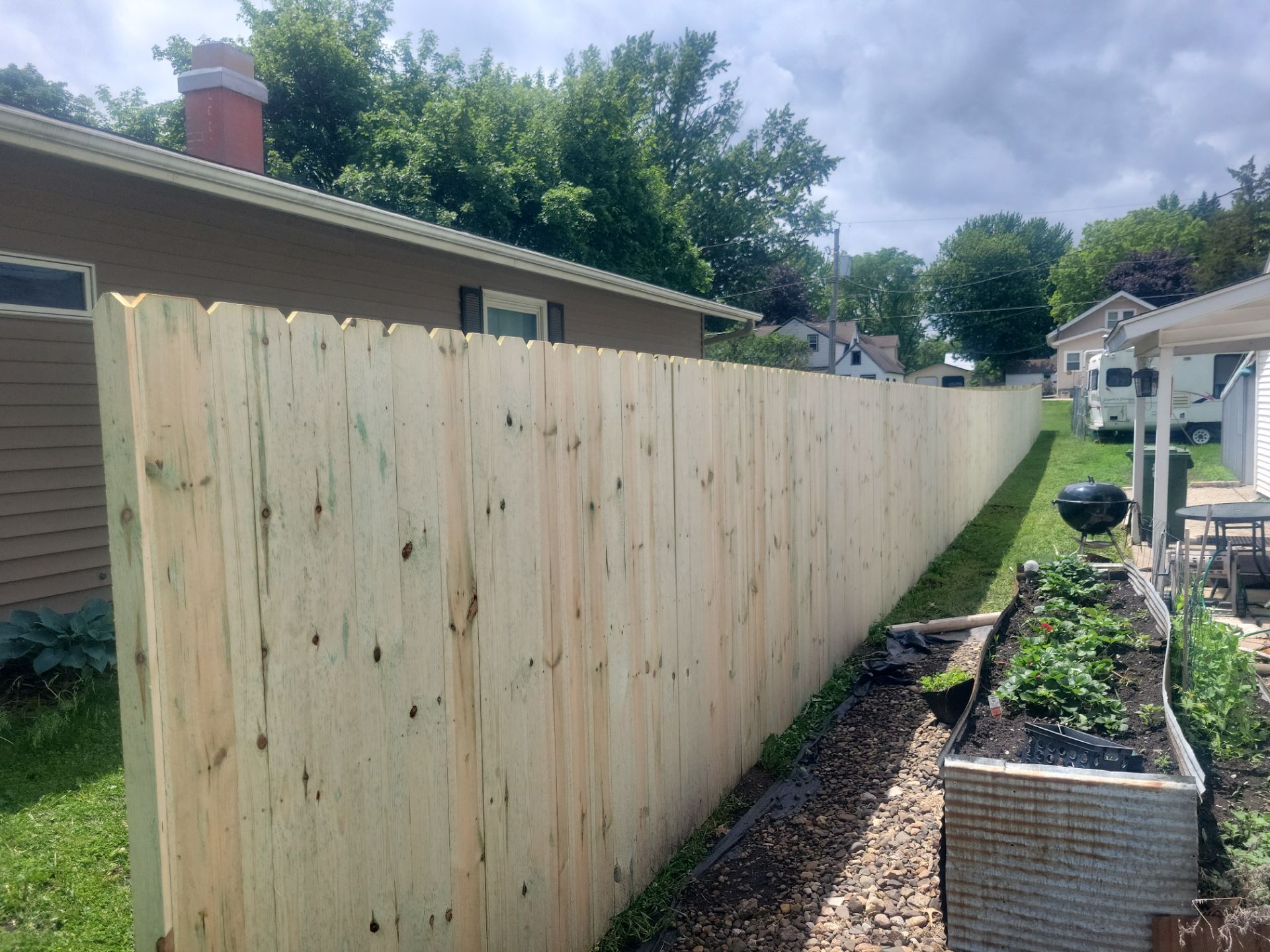 Pressure-Treated Wood Privacy Fence Installation in Charles City by Perfect Picket Fence and Stain