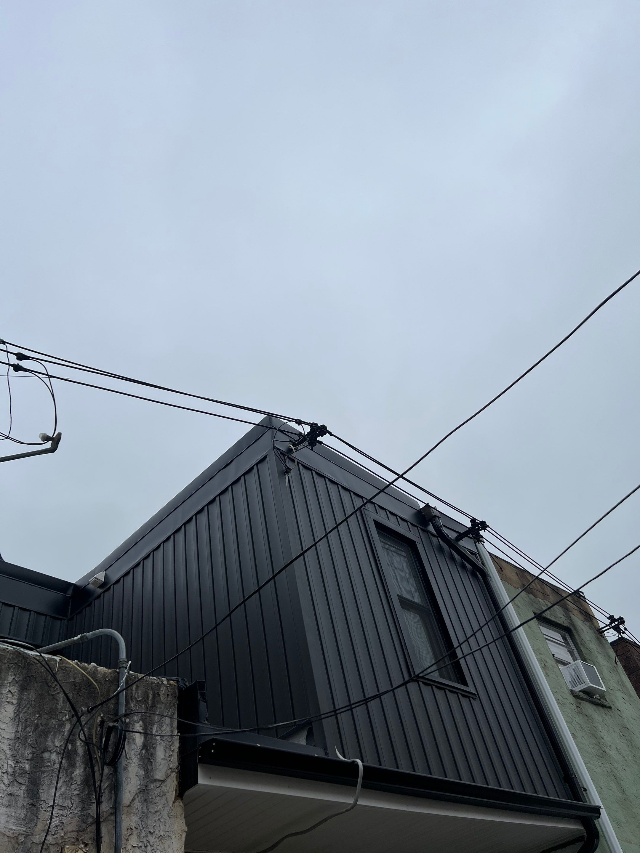 Vertical Black Metal Siding Installation for Philadelphia Home Exterior by Hybrid Roofing And Renovations