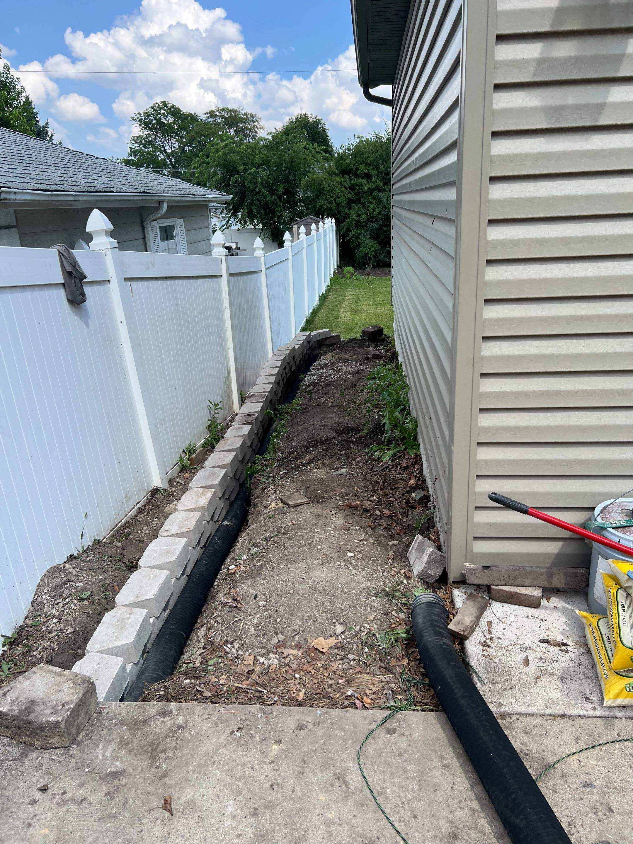Split faced landscape block retaining wall and French Drain Installation by Allied Water Services