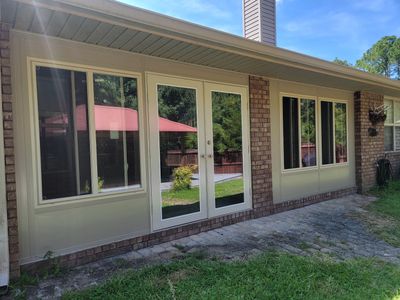 Glass Sunroom Constructed Under Existing Roof