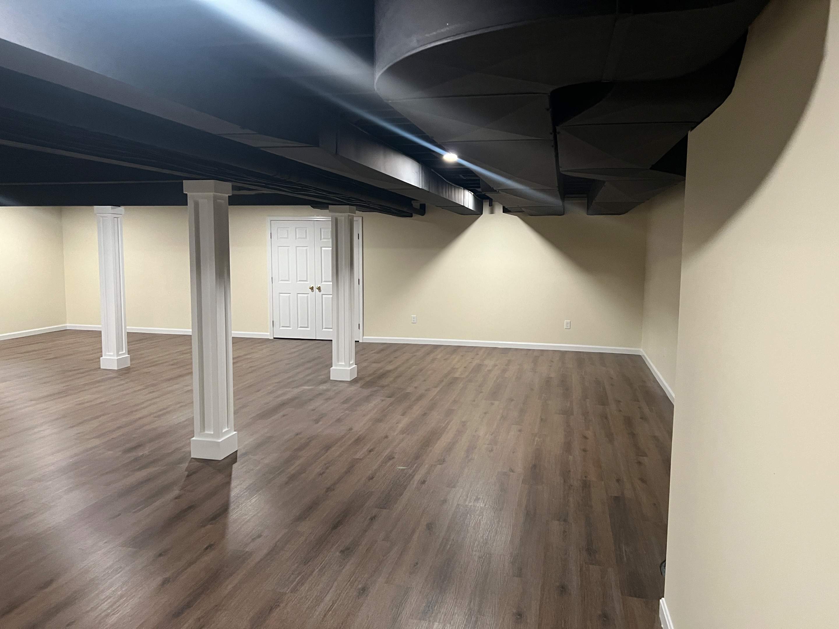 Basement Remodel w/ LVP Flooring & Exposed Ceiling by Chagnon Building & Remodeling LLC