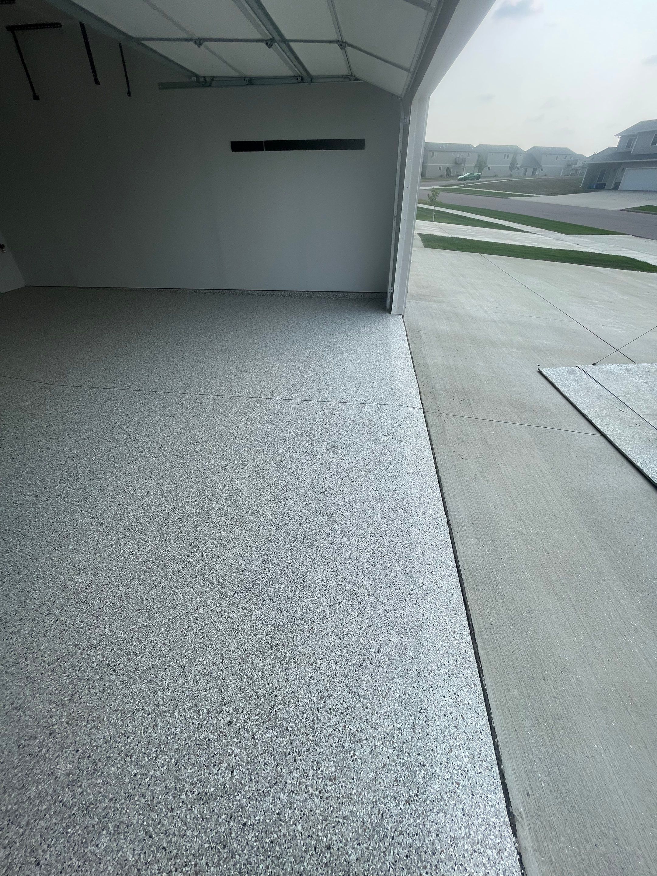 Custom Coyote Flake Garage Floor Coating in Sioux Falls by Select Painting, Coatings & Garage Cabinets