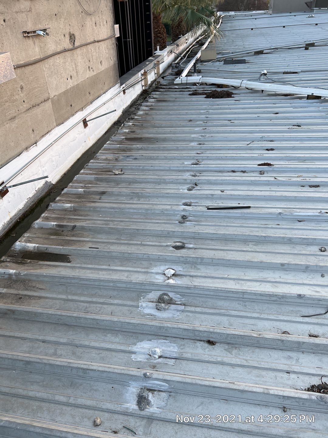 Metal roof restoration on commercial roof using Conklin Benchmark/ PUMA XL acrylic coatings over metal and foam by Straight Edge Roofing Inc