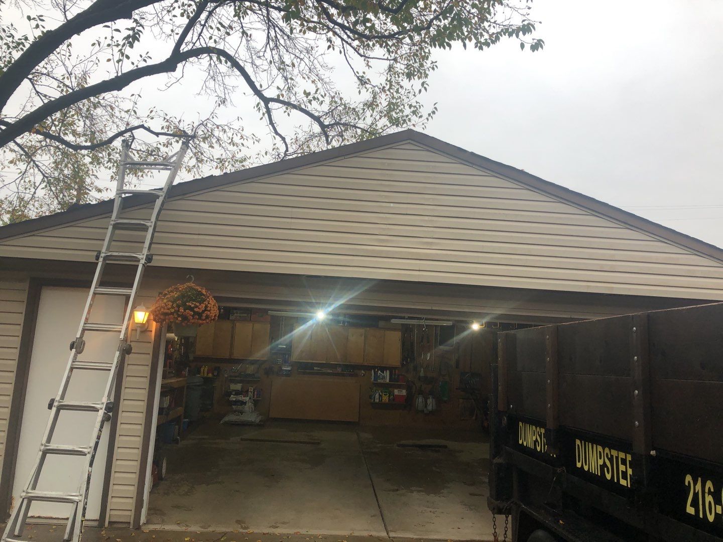 Siding Installation using Norandex woodsman dl-5 white woodgrain vinyl by Absolute Roofing and Construction