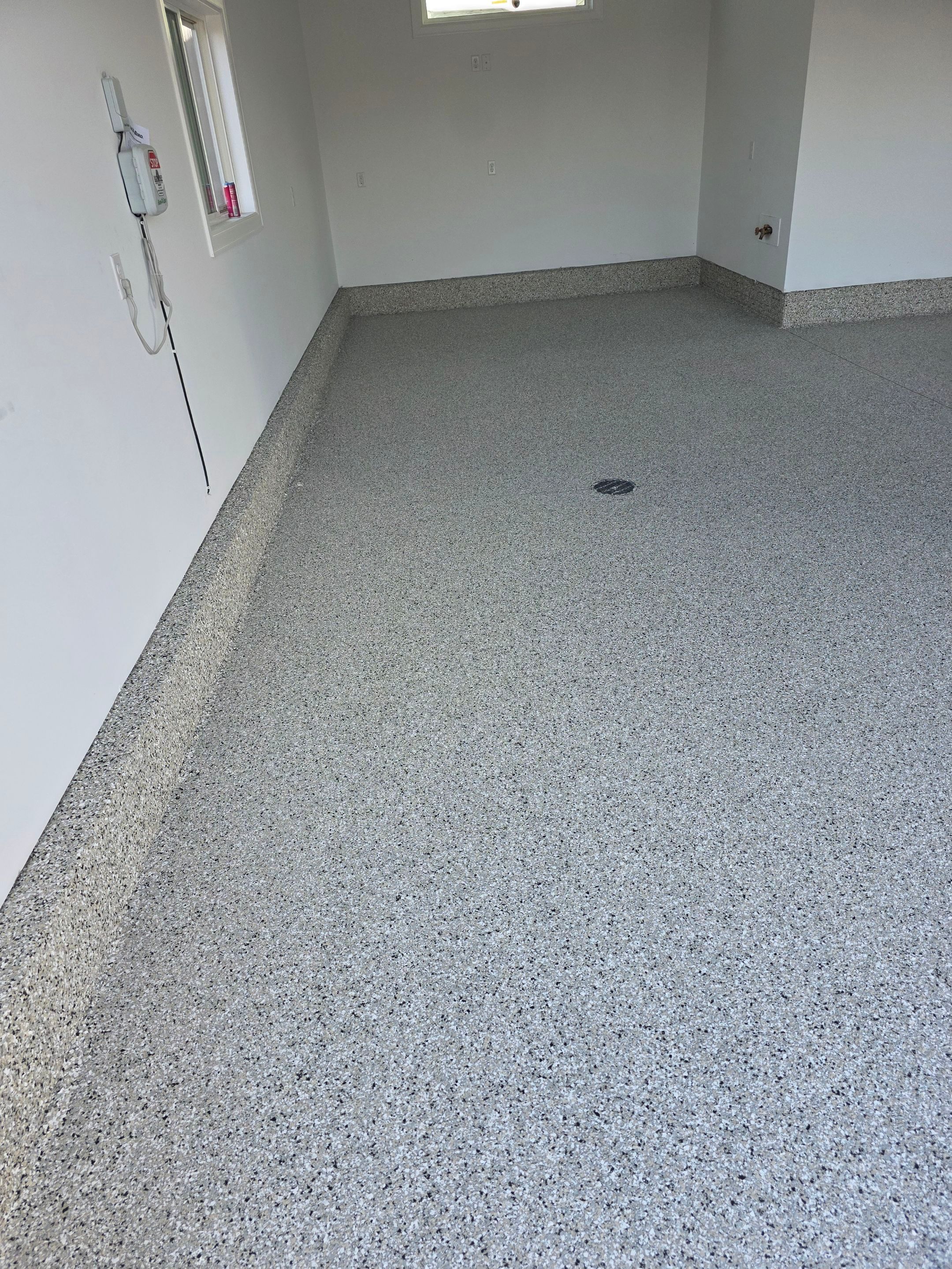 Gray and Black Speckled Polyurea Garage Floor in Dell Rapids by Select Painting, Coatings & Garage Cabinets