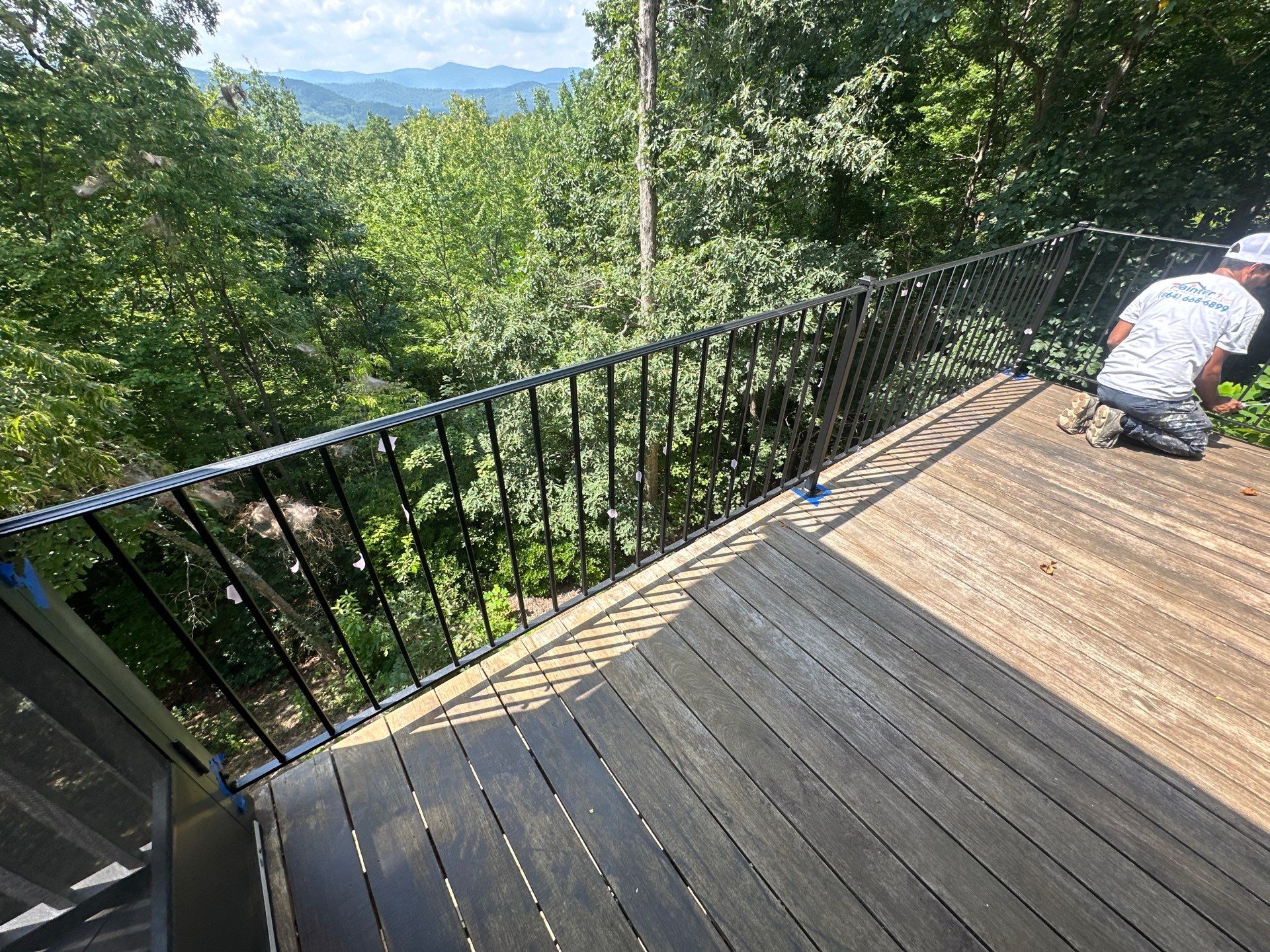 Wood Deck Refinishing and Black Metal Railing Upgrade in Travelers Rest by Painter1