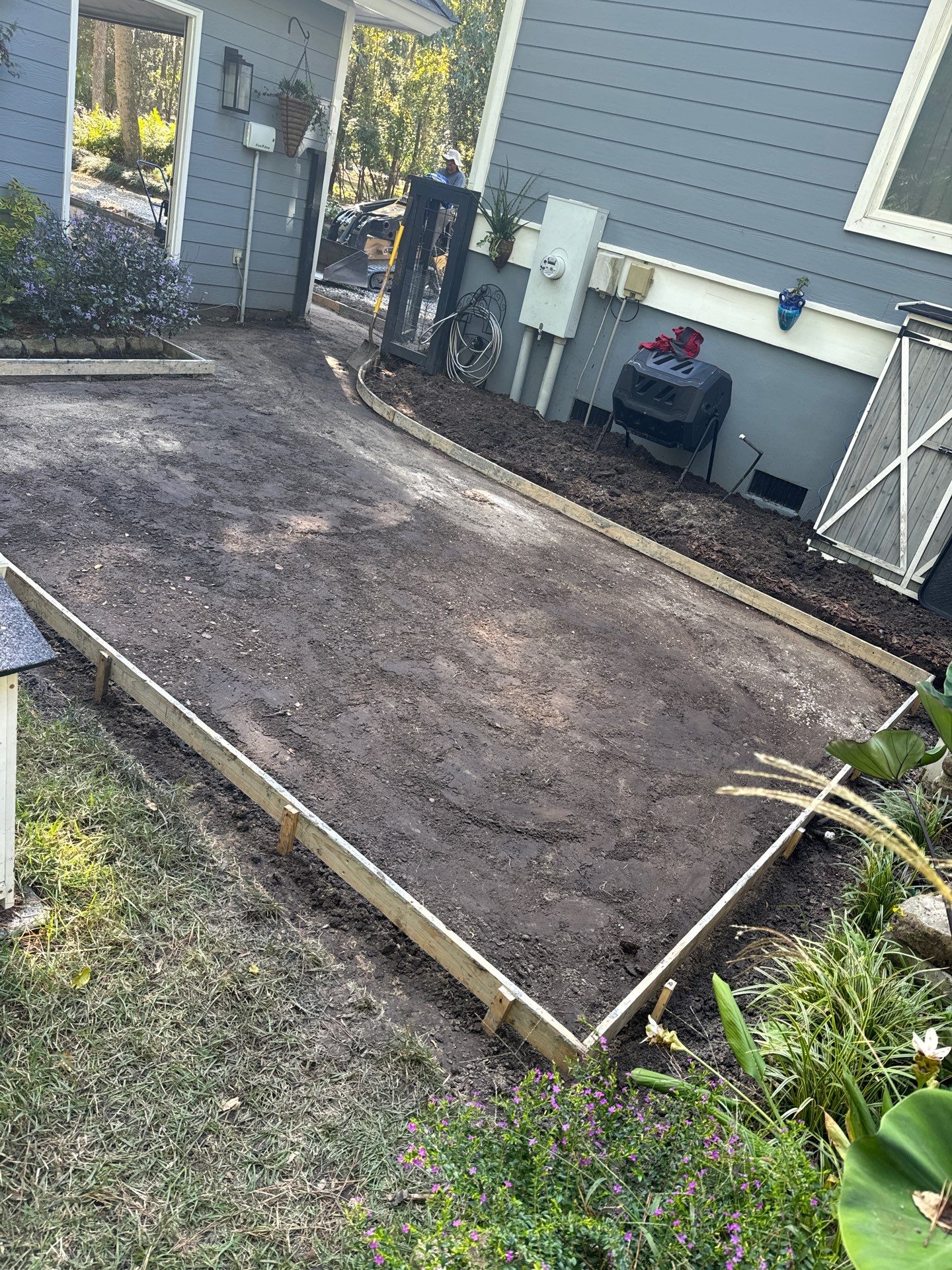 Concrete Driveway and Patio Installation With Decorative Brick Borders by Lowcountry Scapes, LLC