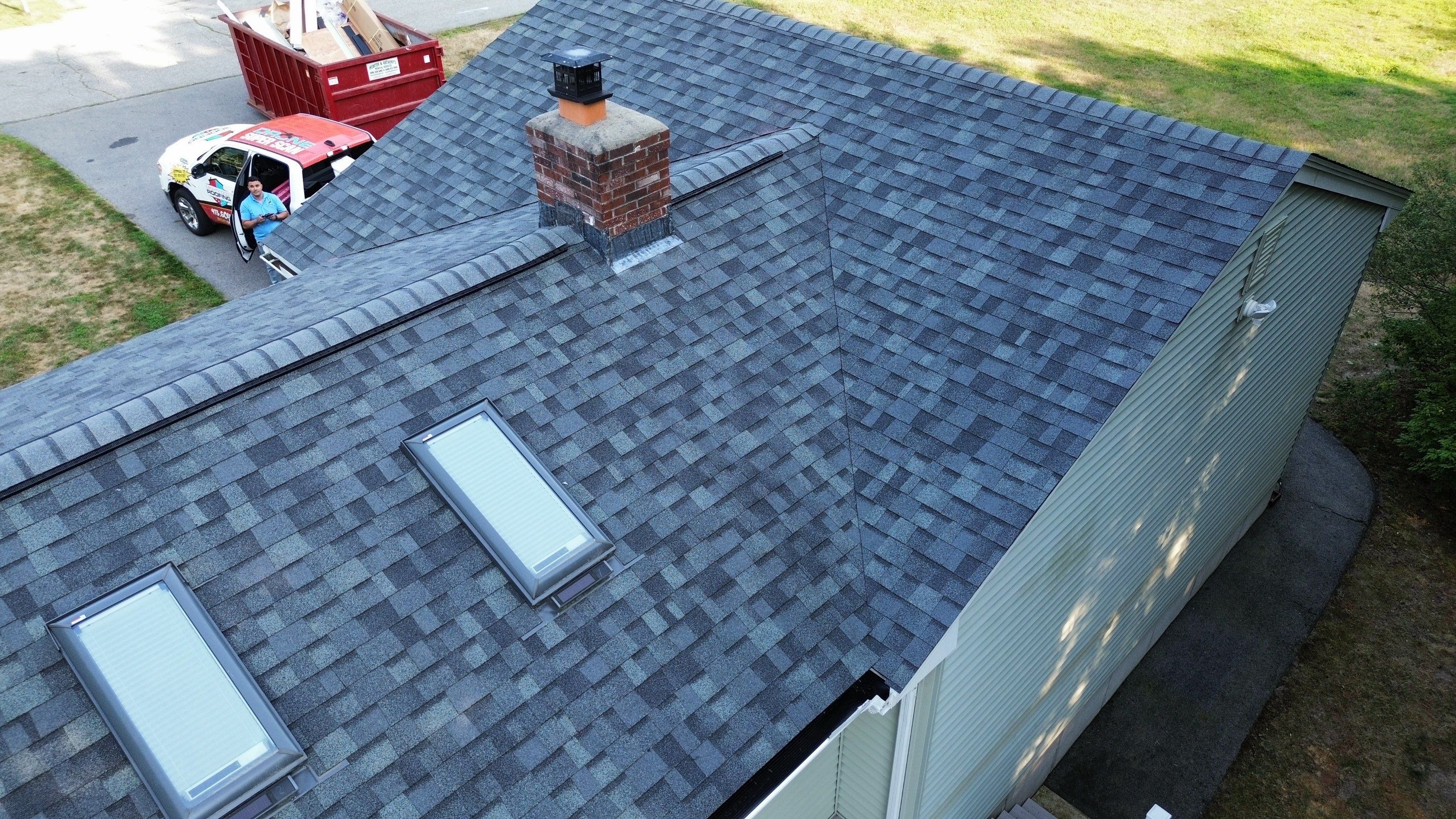 Complete Roof Replacement with Chimney Flashing, Gutter Guard System, and Vinyl Siding Repairs by Mighty Dog Roofing of Greater Middlesex County