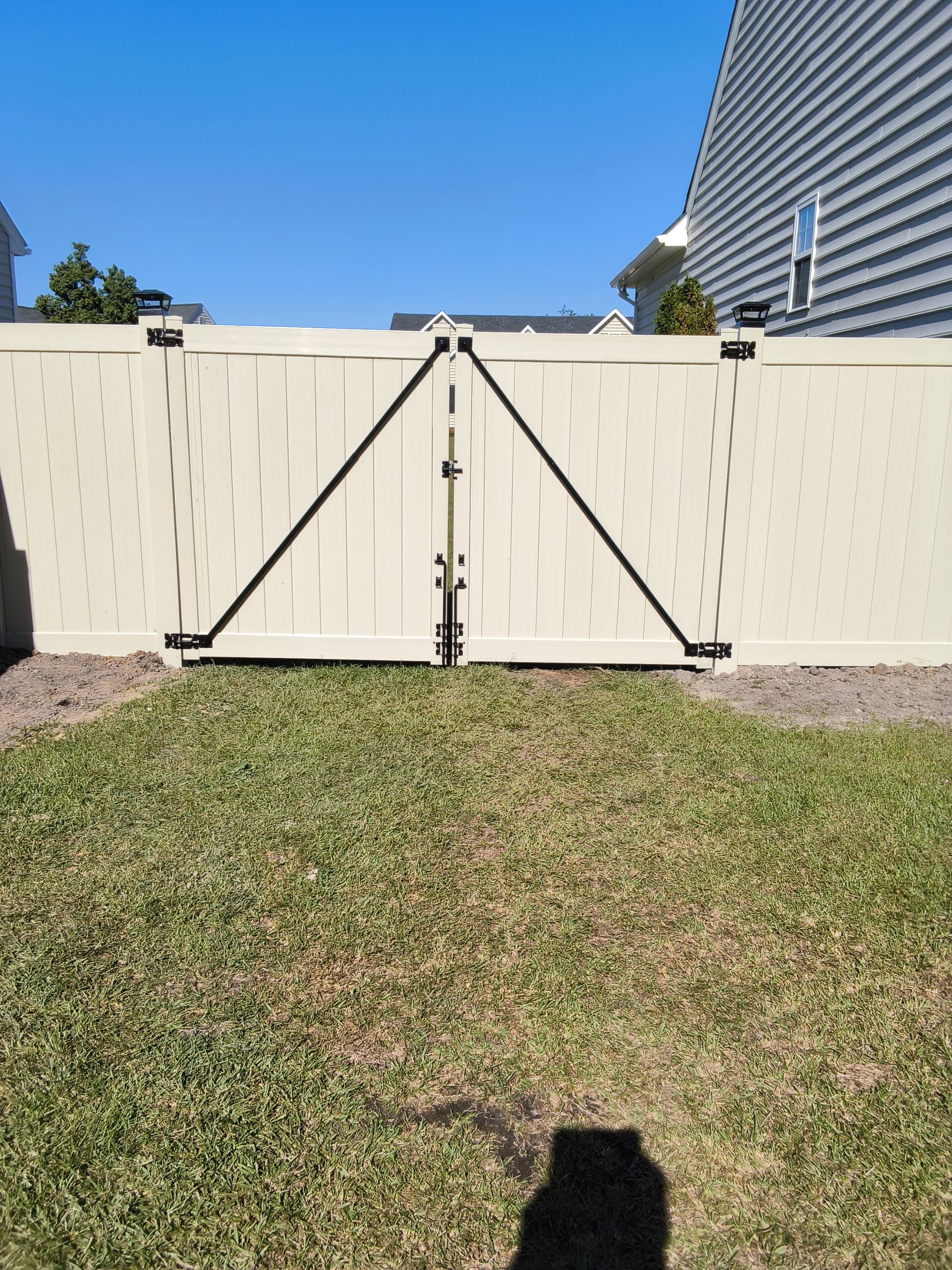 Custom Tan Vinyl Privacy Fence Installation with Double Gates in Winterville by Superior Fence and Rail