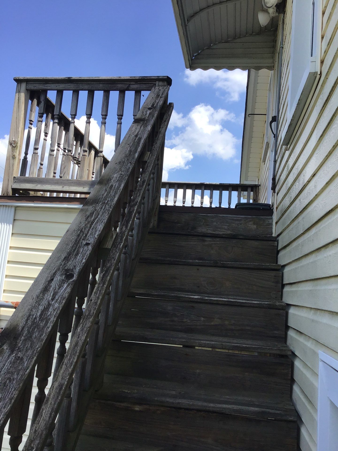 Rebuild balcony flat roofing TREX decking stairway and Railings in Wyandotte, MI by Northwest Construction 