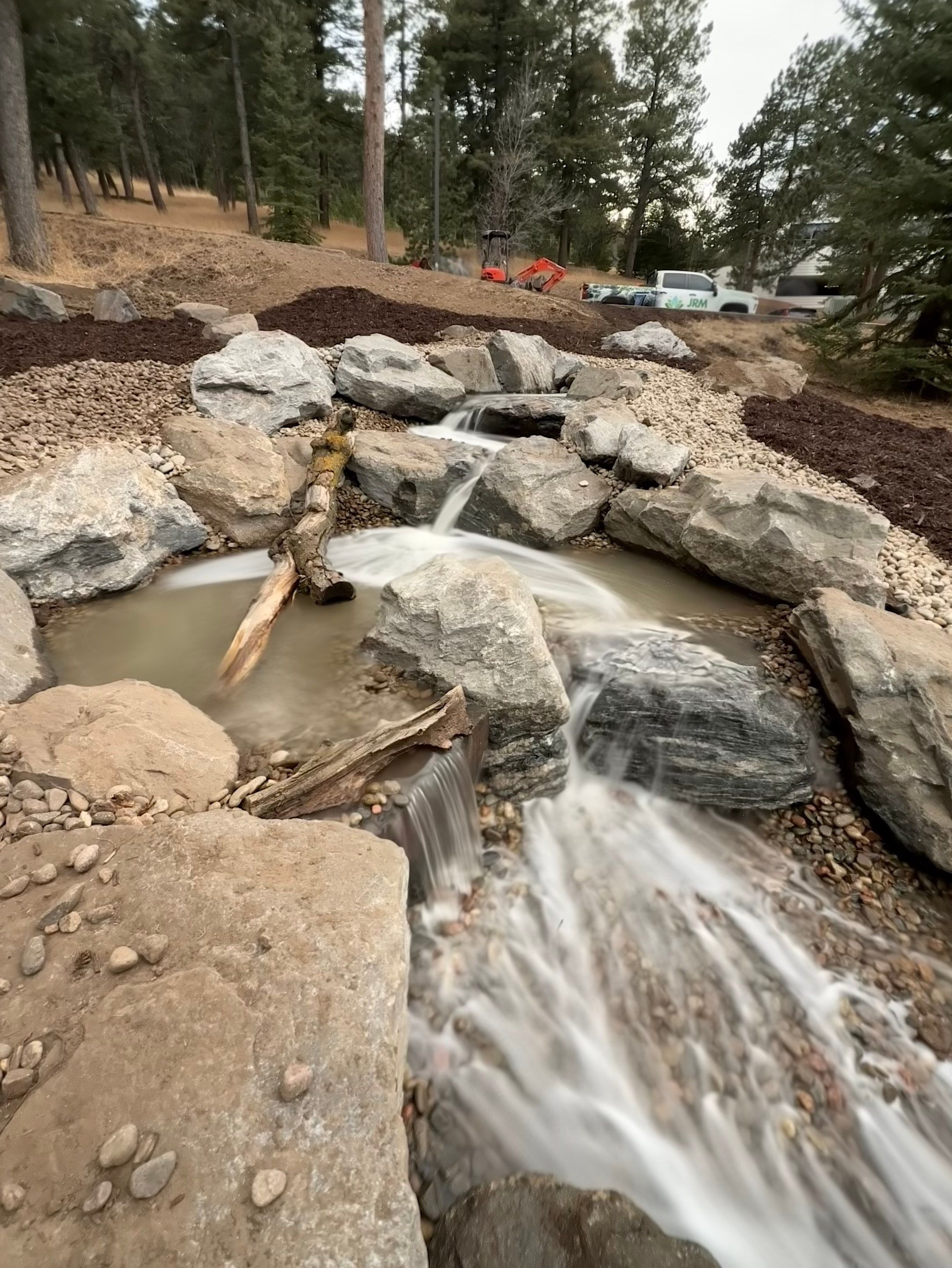 large waterfall and deck by JRM landscape & design