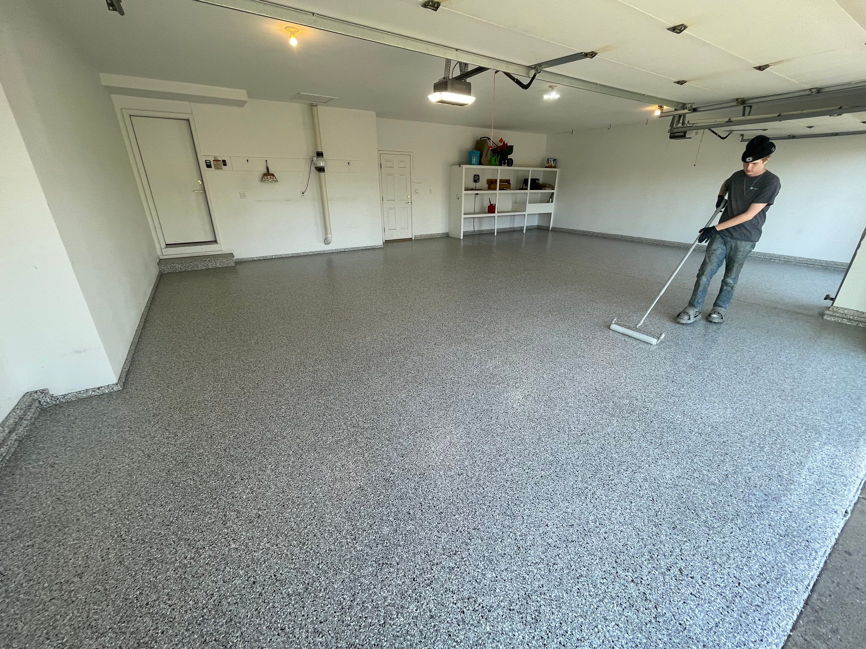 Yankton Garage Floor Restoration with Gray Speckled Epoxy Coating by Select Painting, Coatings & Garage Cabinets