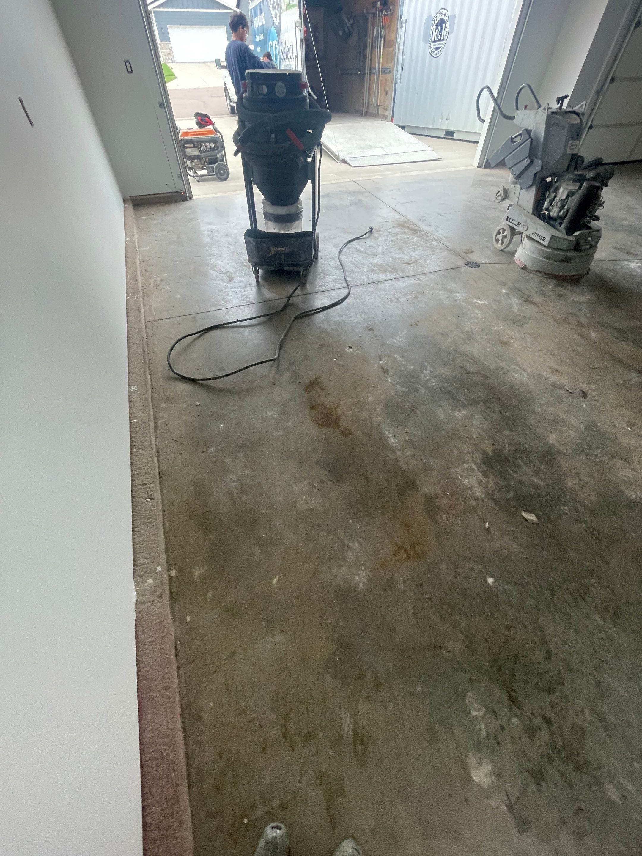 Grey Flake Epoxy Garage Floor Coating in Sioux Falls by Select Painting, Coatings & Garage Cabinets