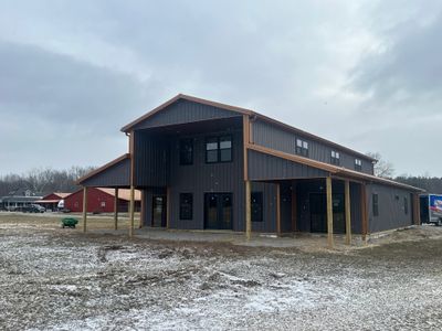 Custom Pole Barn Home with Charcoal Siding and Copper Roof