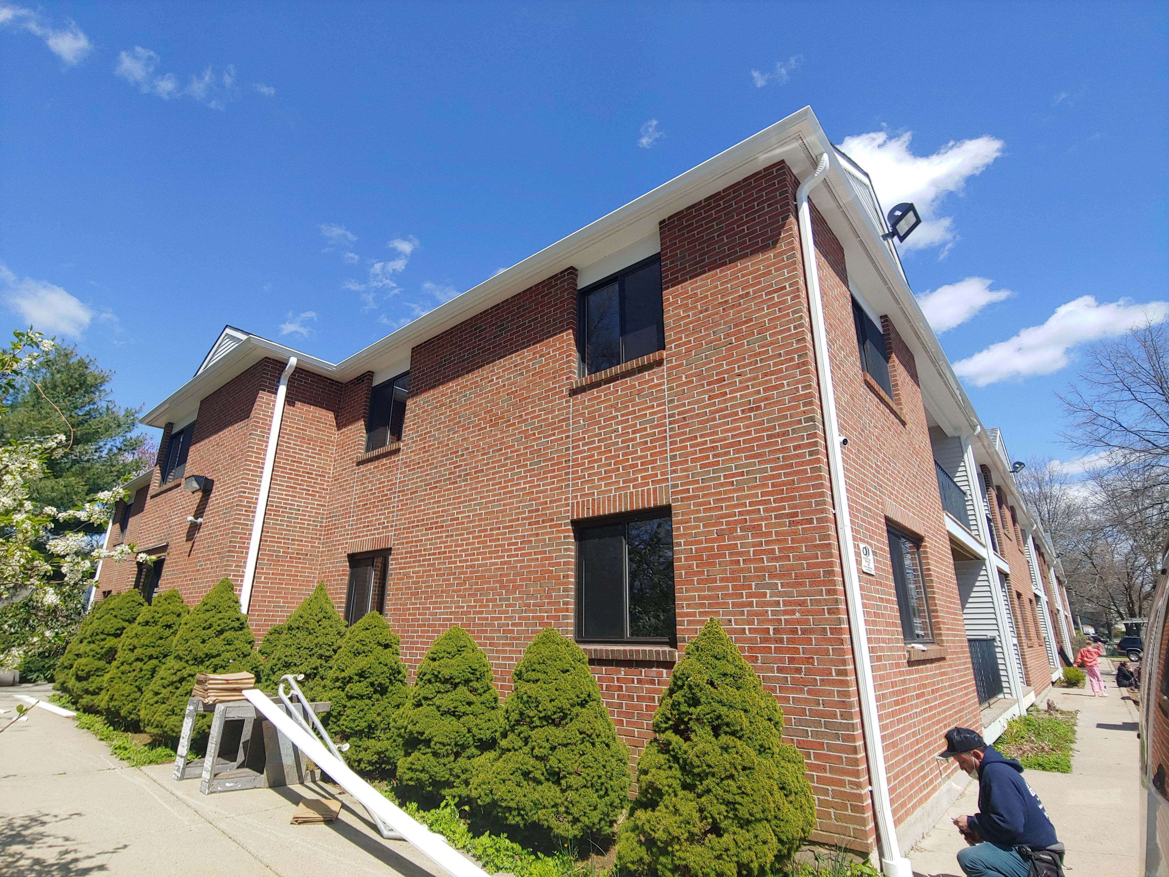 Commercial Roofing Installation using EPDM with white gutters by A Plus Exterior