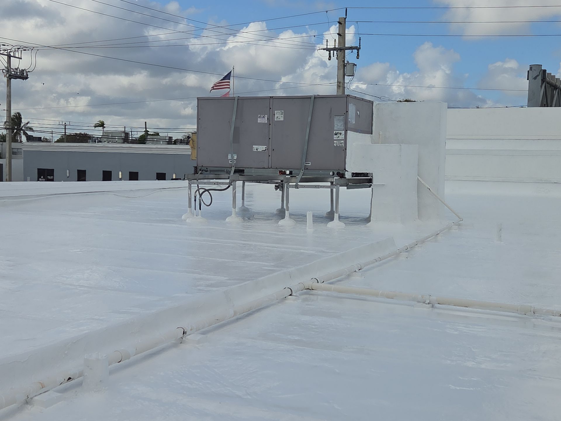 Commercial Flat Roof Restoration Using Silicone Coating in Hallandale Beach by Aastro Roofing