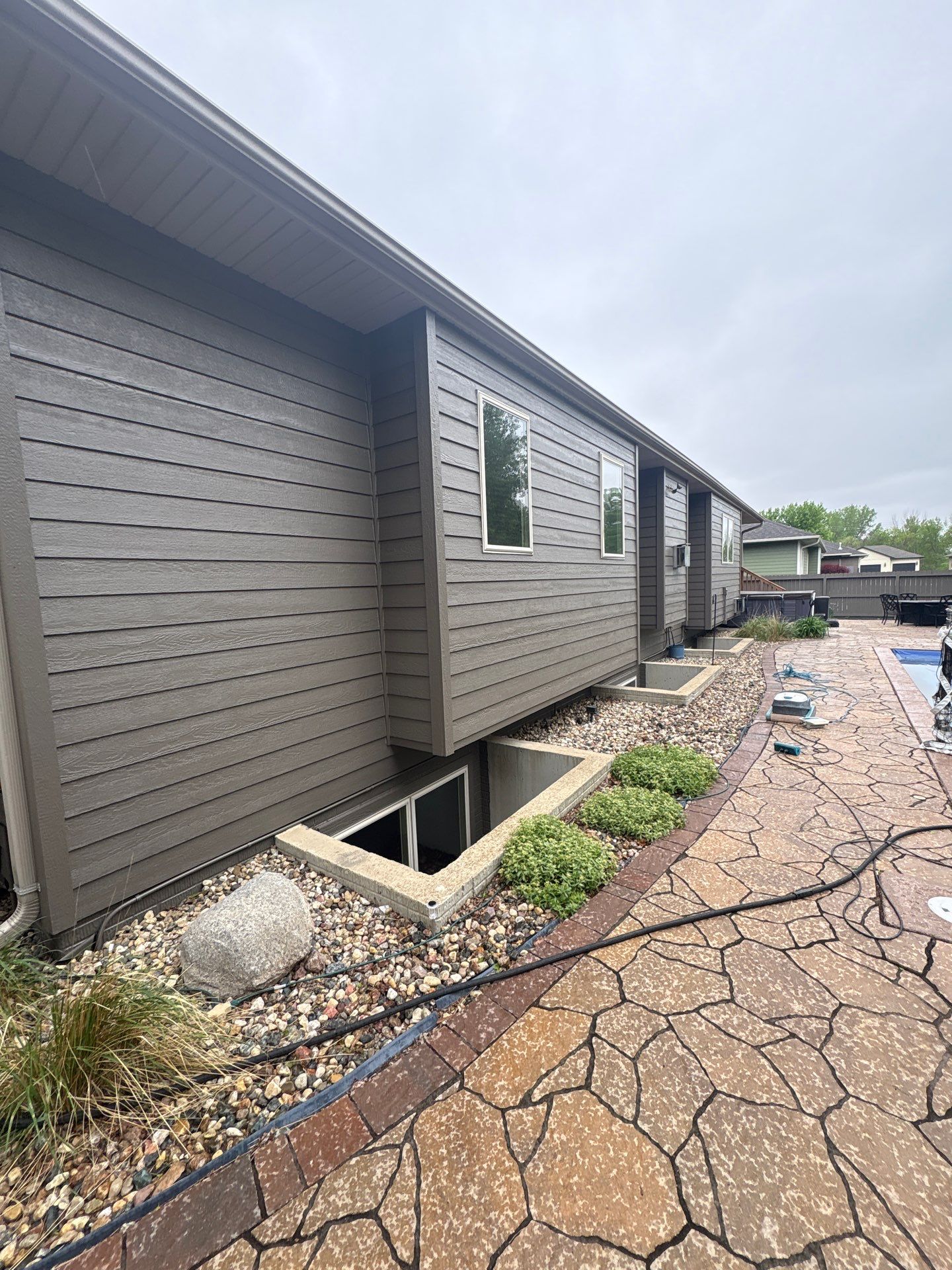 Sioux Falls Residential Exterior Update and Flagstone Pool Deck by Select Painting, Coatings & Garage Cabinets