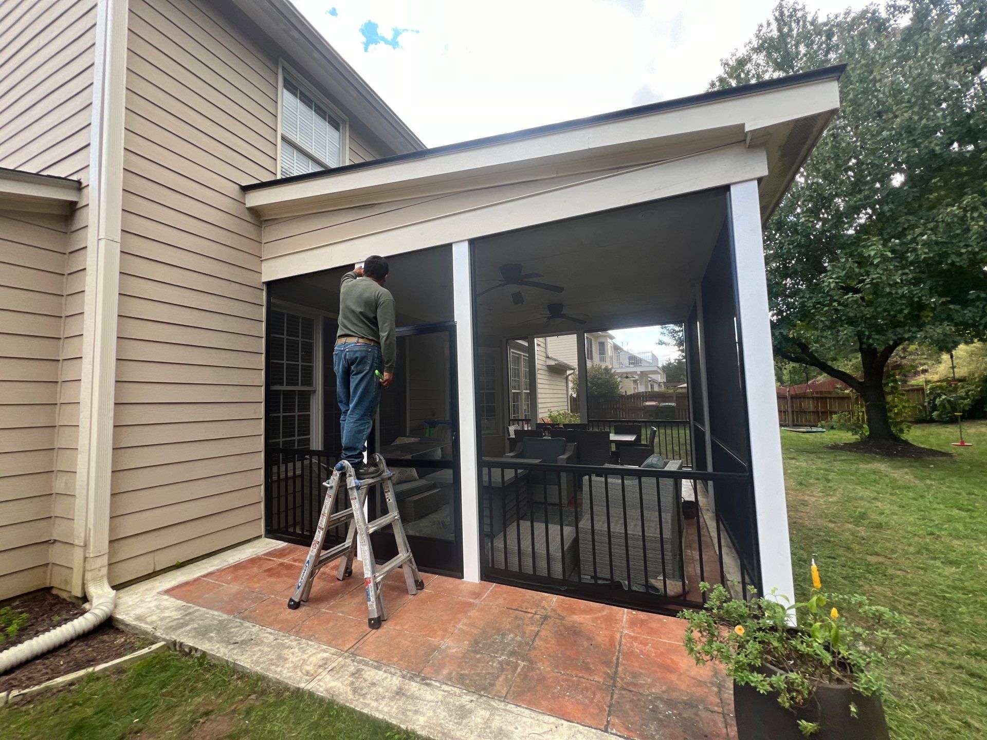 Screened-In Porch Conversion Featuring 6x6 Posts and Black Railings by The Remodeling Company