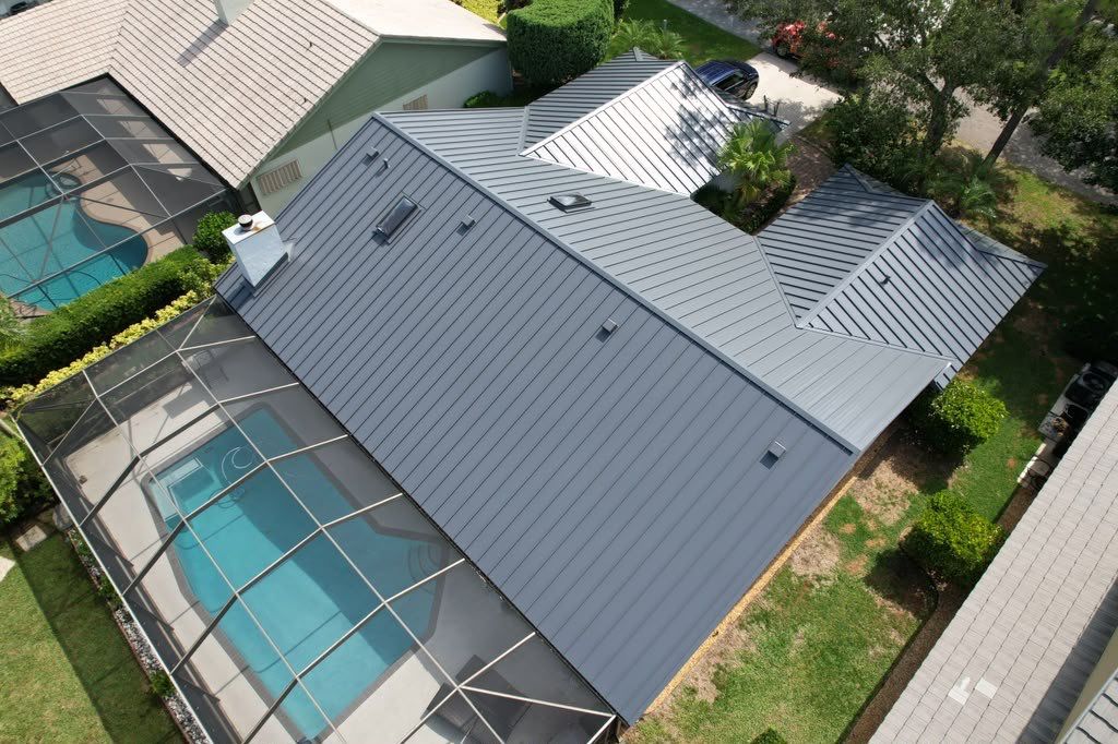 Standing Seam Metal Charcoal Grey Roof Replacement and Skylight Installation in Jupiter by Art's Roofing & Construction