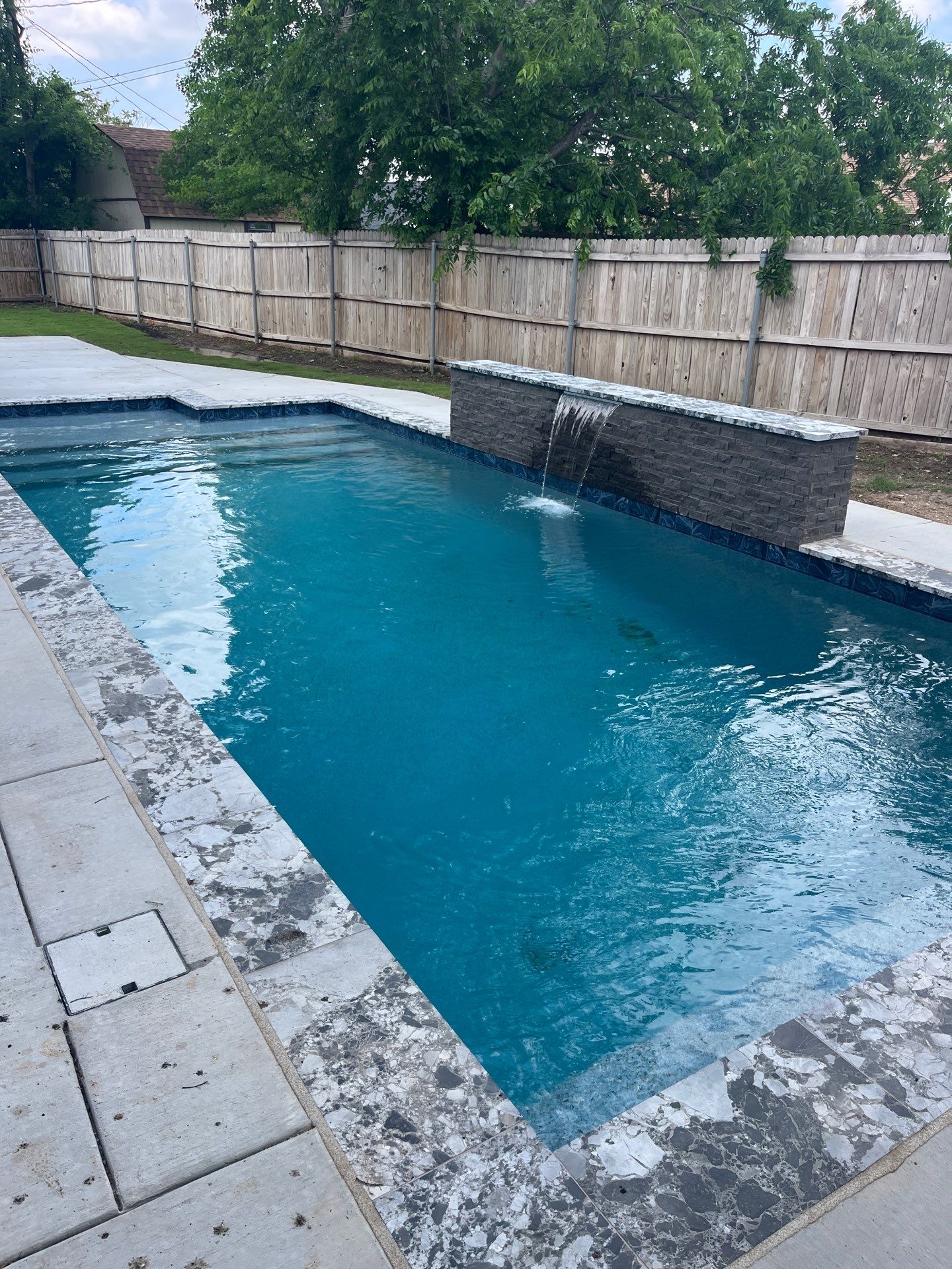 Geometric Pool with Stone Waterfall Wall by Pinnacle Pools and Spas - DFW
