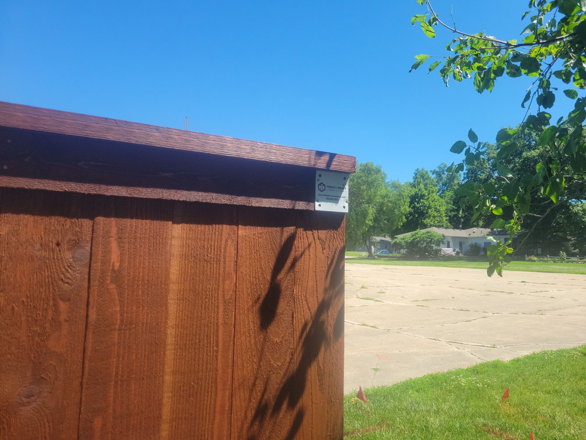 Custom Stained Cedar Chestnut Privacy Fence Installation in Cedar Falls by Perfect Picket Fence and Stain
