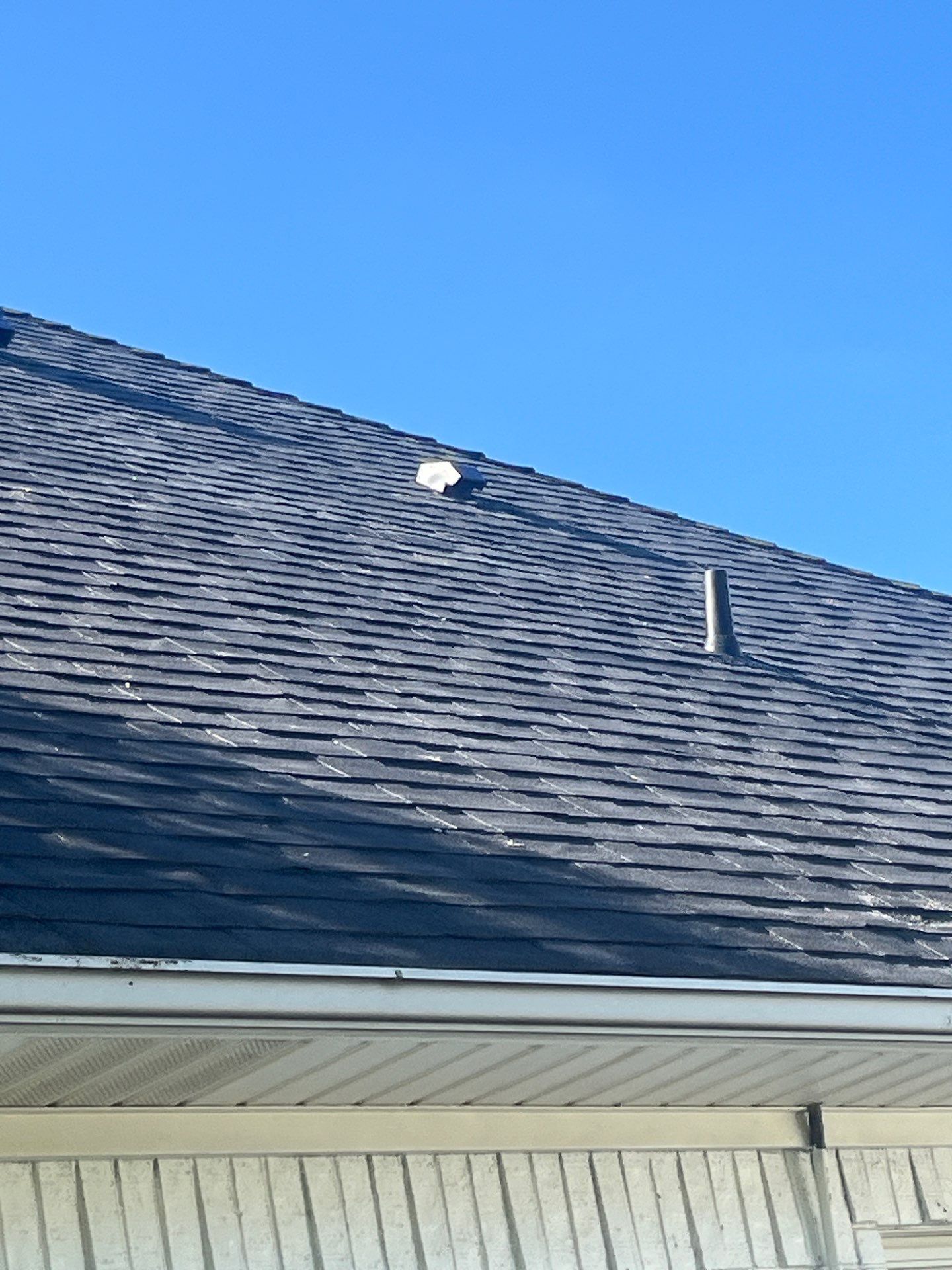 White brick with Malarkey Brilliant Black by Tejas Roofworks + Restoration